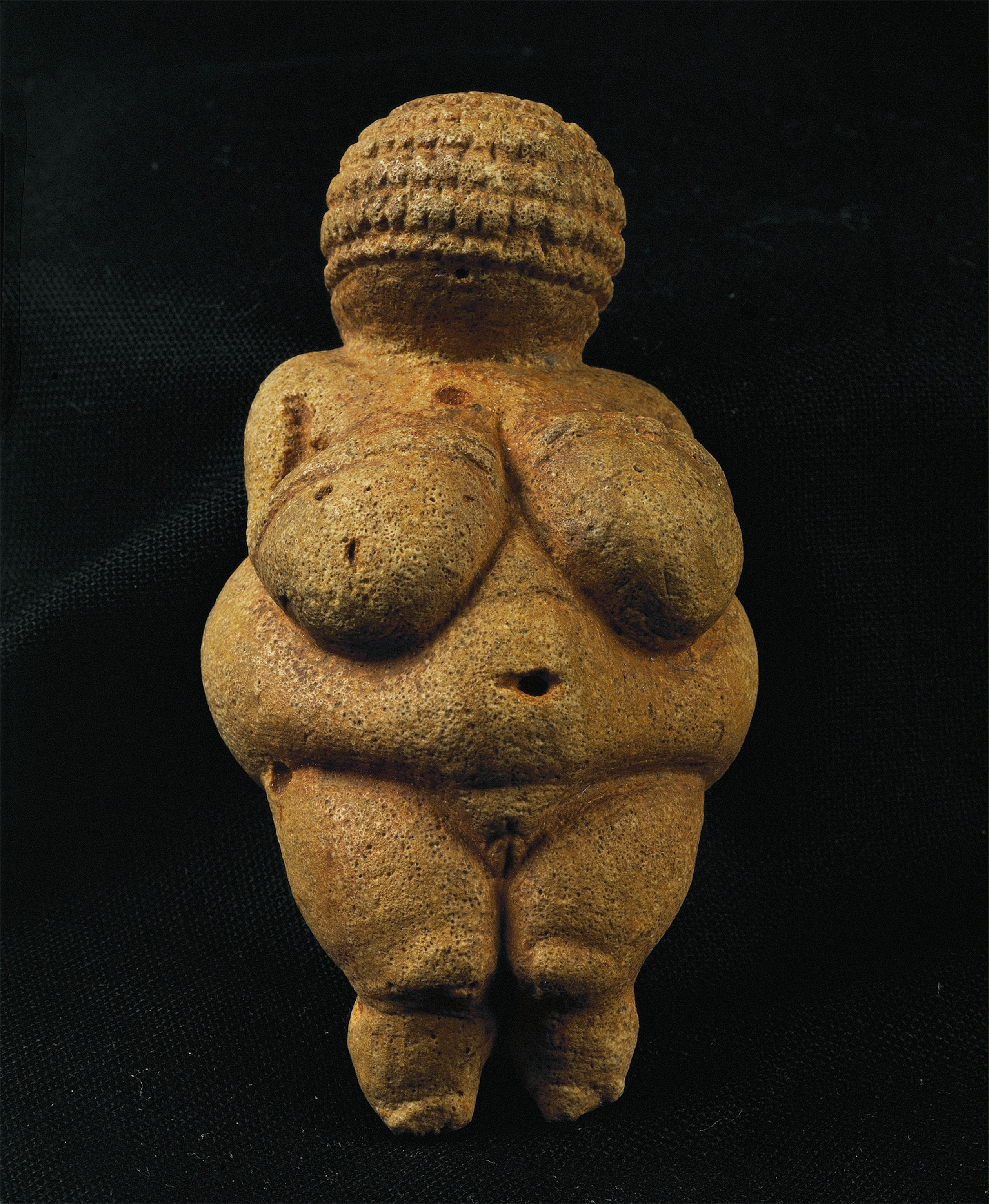 The front of a red ocher Venus statue is pictured.