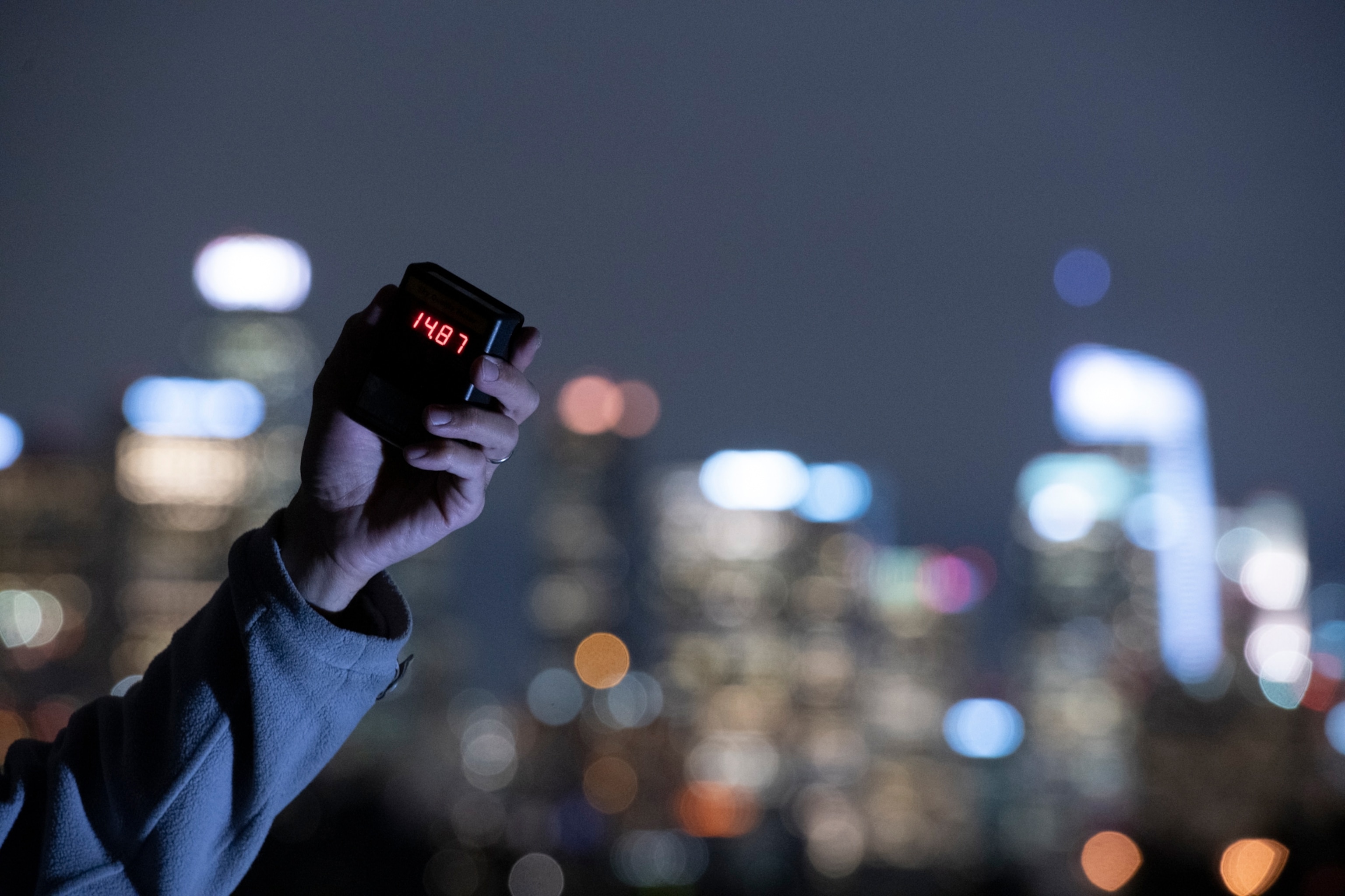 a hand holding a A Sky Quality Meter