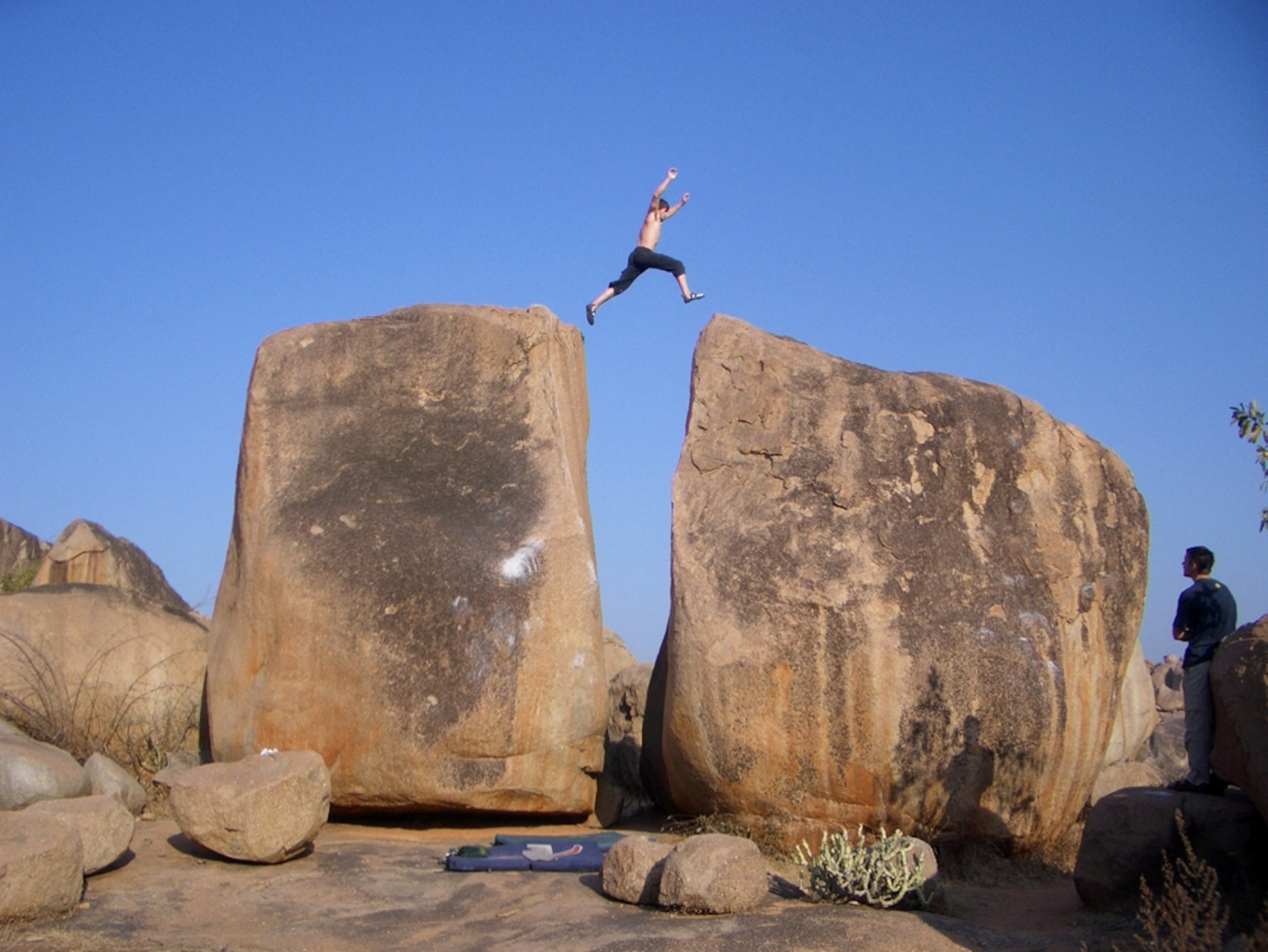 Man jumping from one rock to another