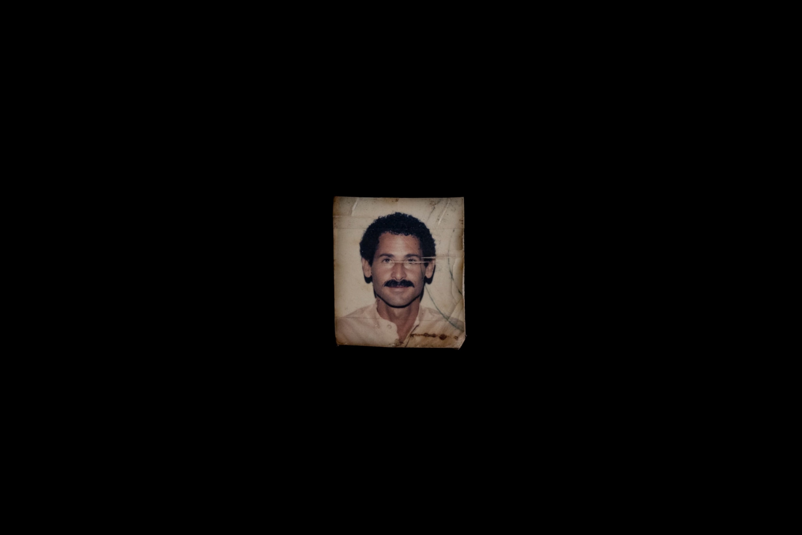 a picture of a man against a black backdrop