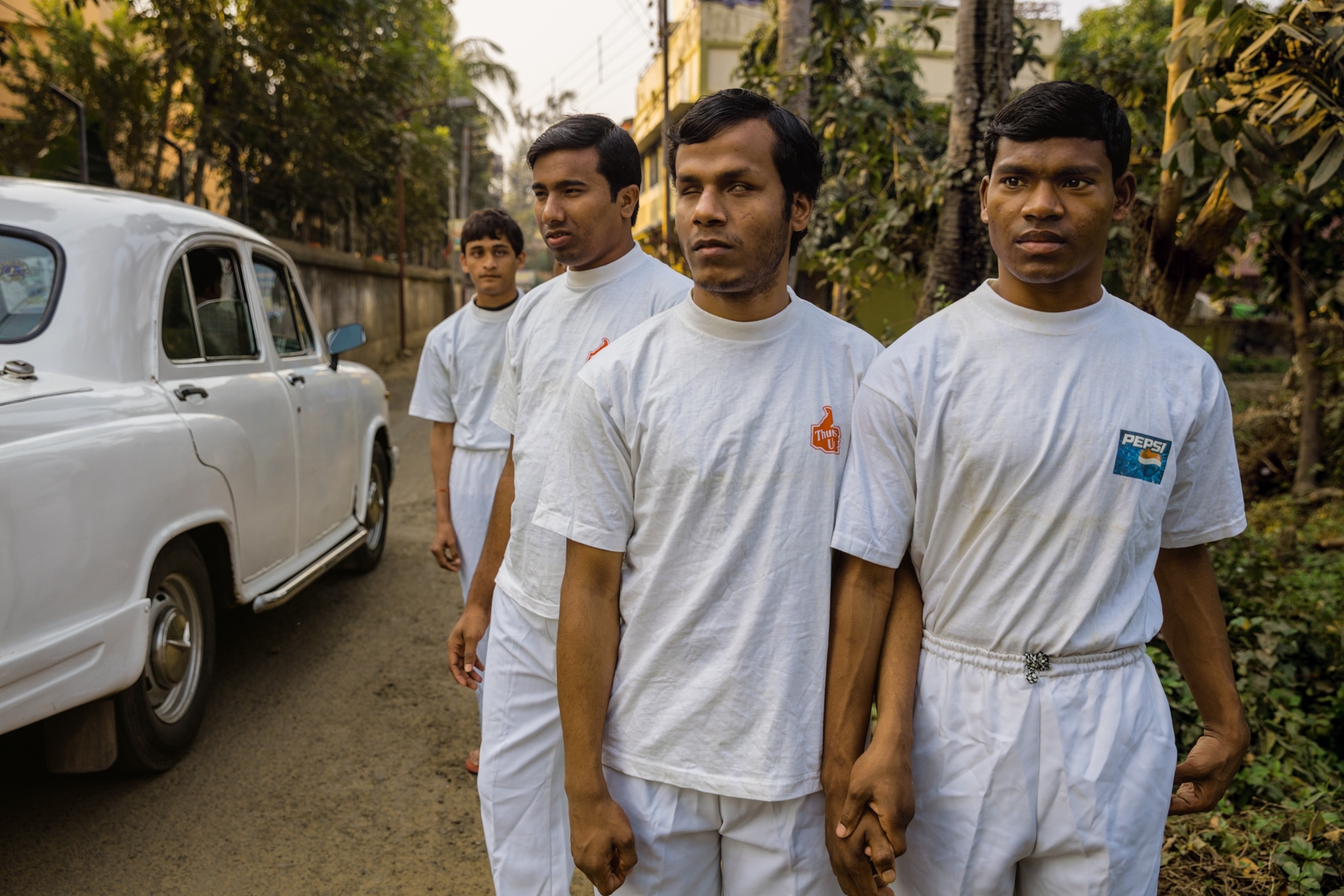 blind students walking hand in hand to gym class in West Bengal, India