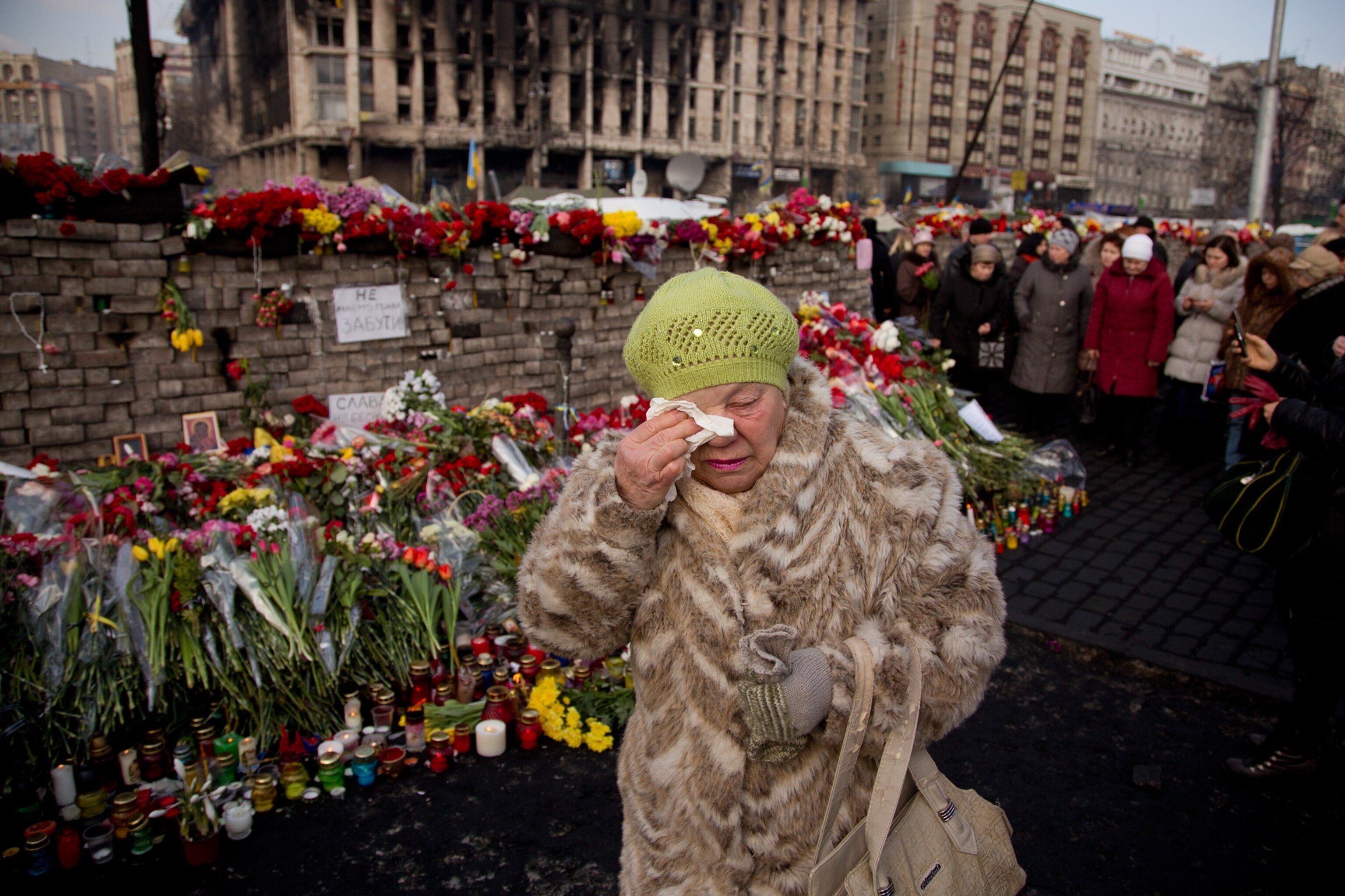A woman cries near a memorial for the people killed in clashes in Kiev.
