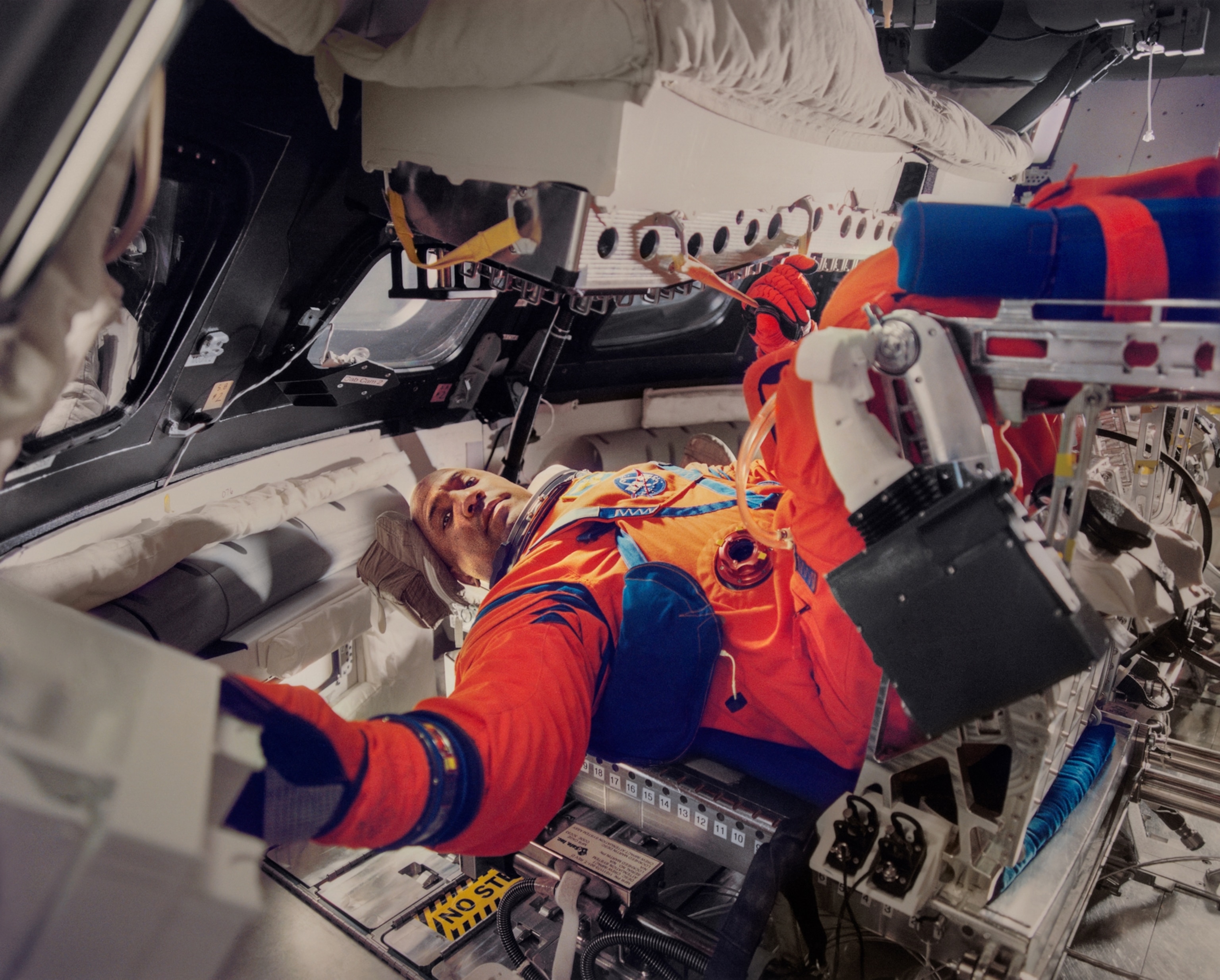 A man is in a space suit photographed in NASA's Space Center