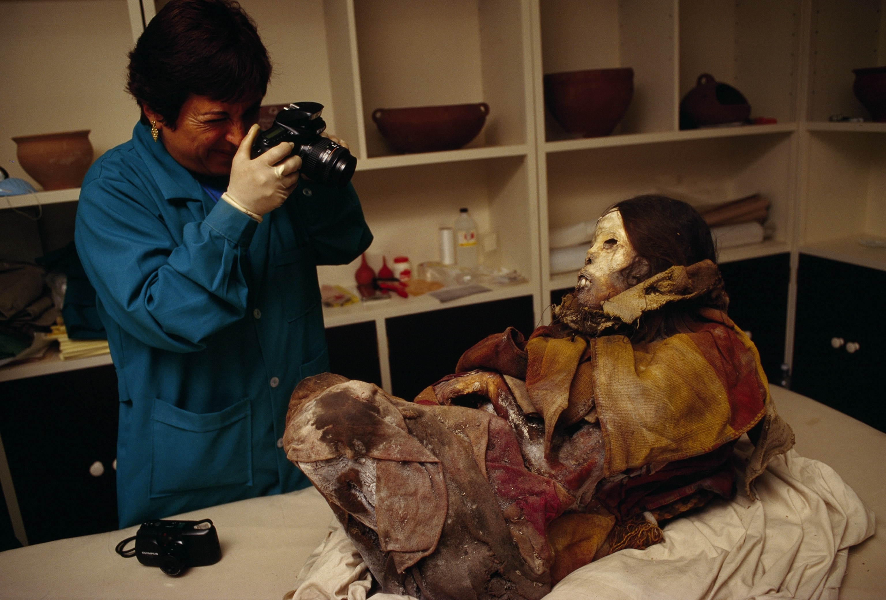 One of Peru's leading mummy experts, Sonia Guillen, photographs the Peruvian mummy named "Juanita."