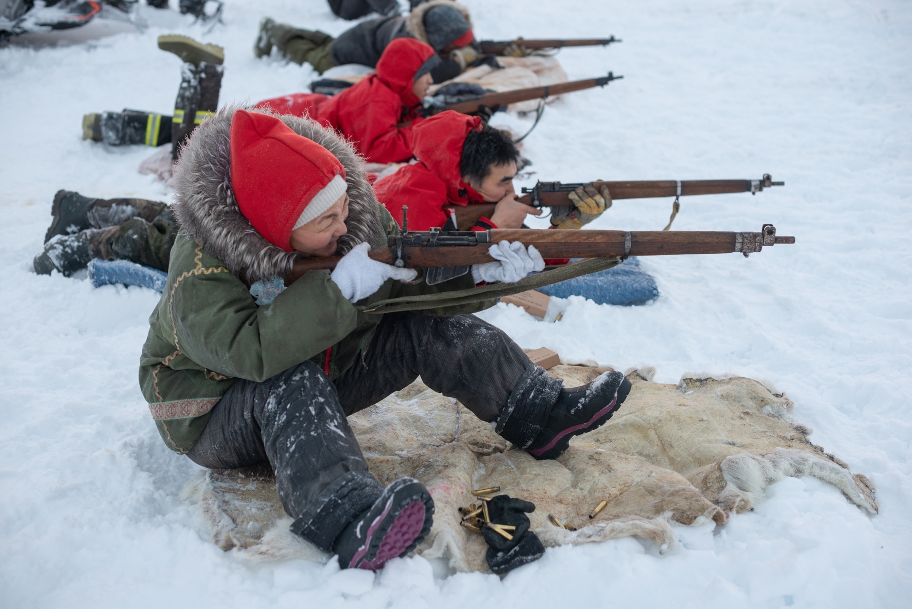 female ranger with soldiers firing guns