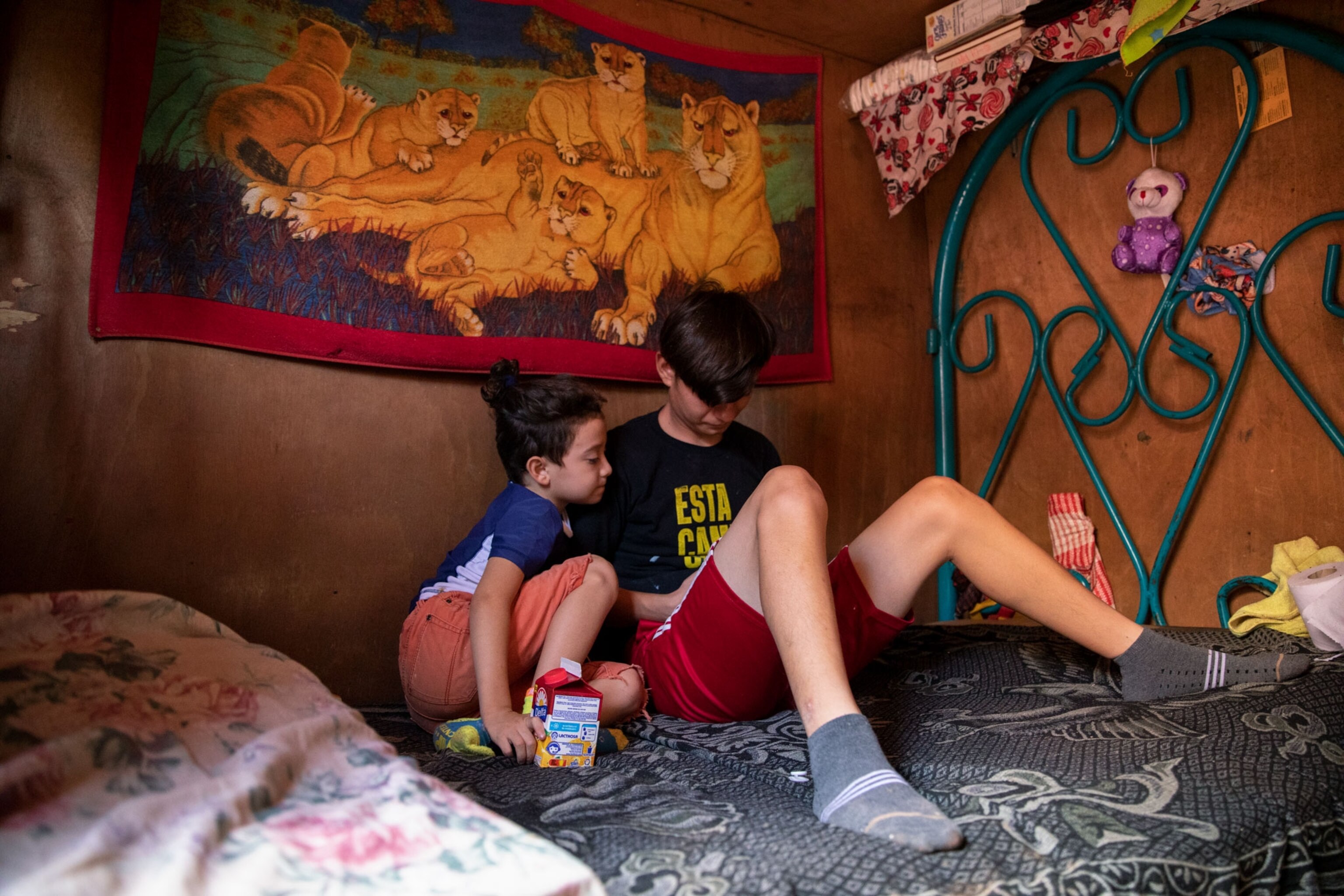 two boys watching videos on a phone in Honduras