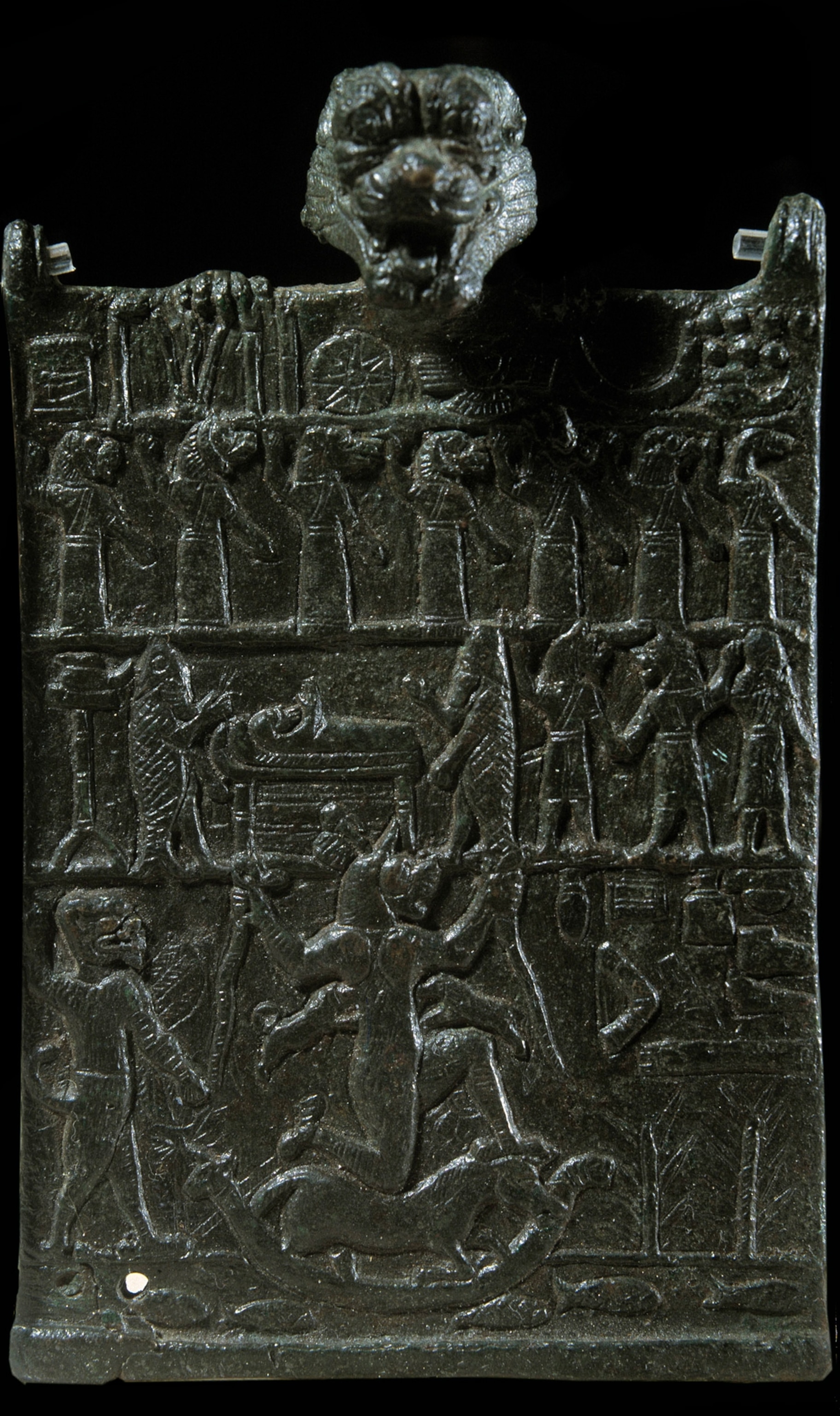 Photo of black tablet with gargoyle-like head at top and panels across telling story