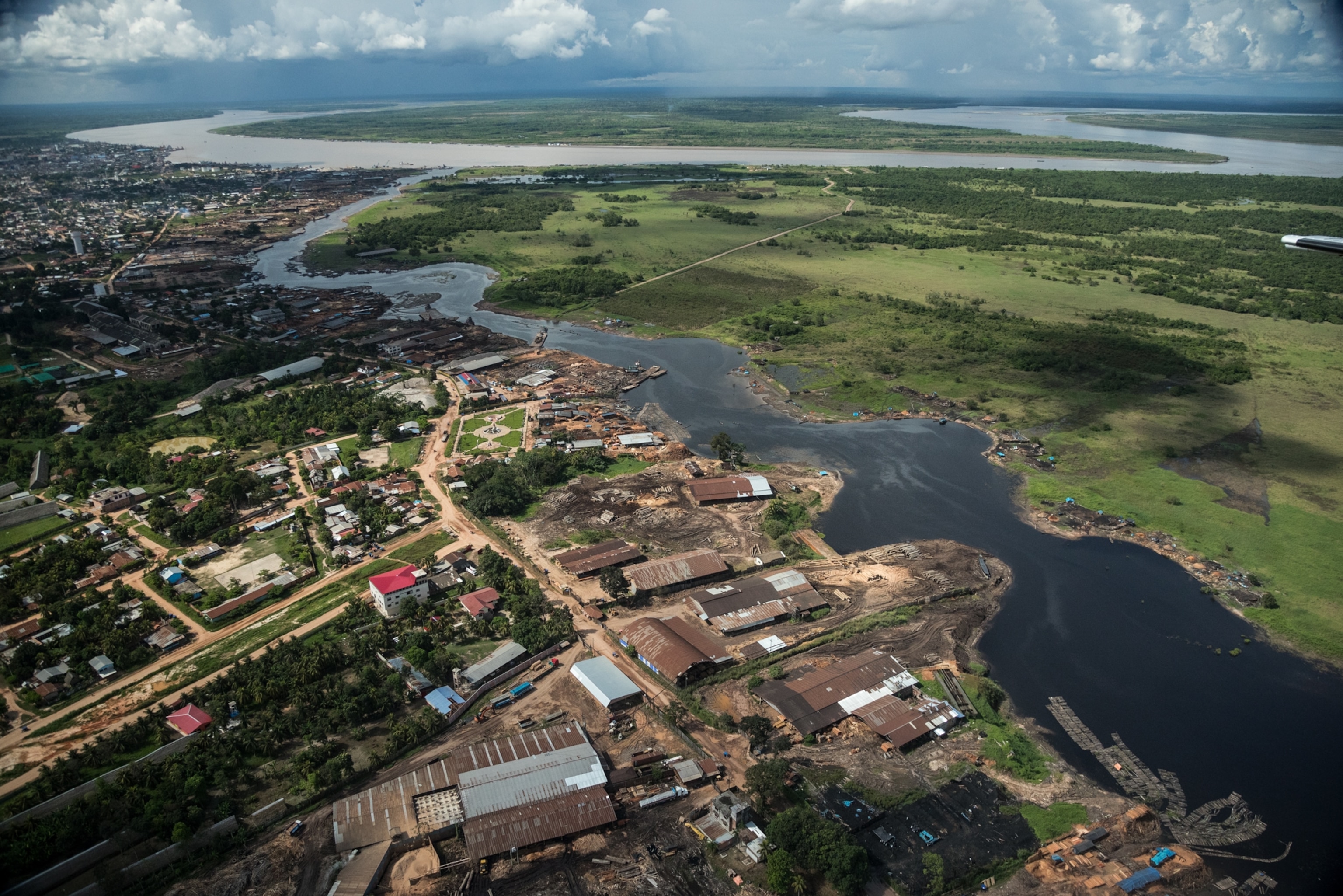 an aerial view of a river next to a port-like area