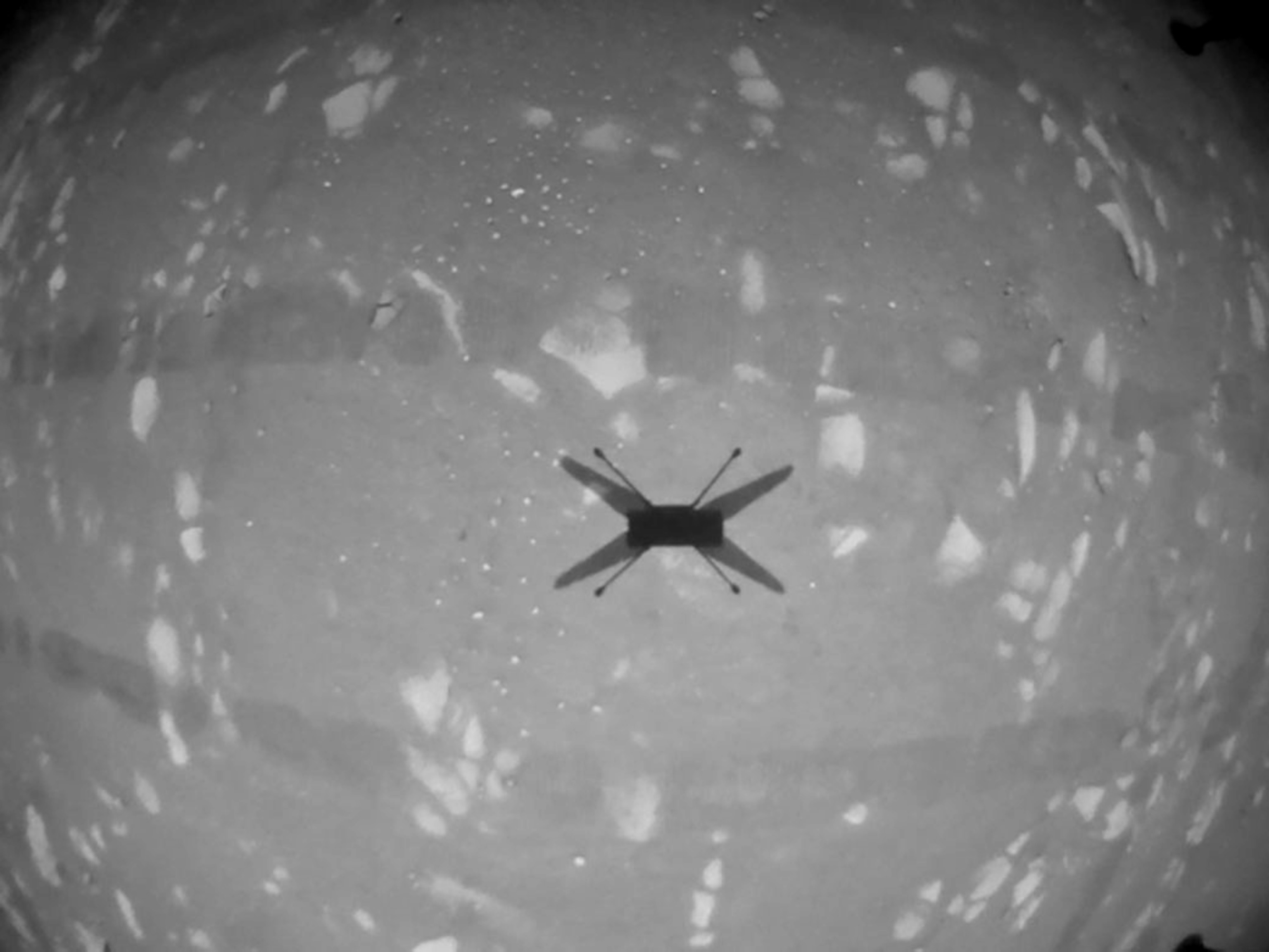 Picture of black and white photo of helicopter's shadow.