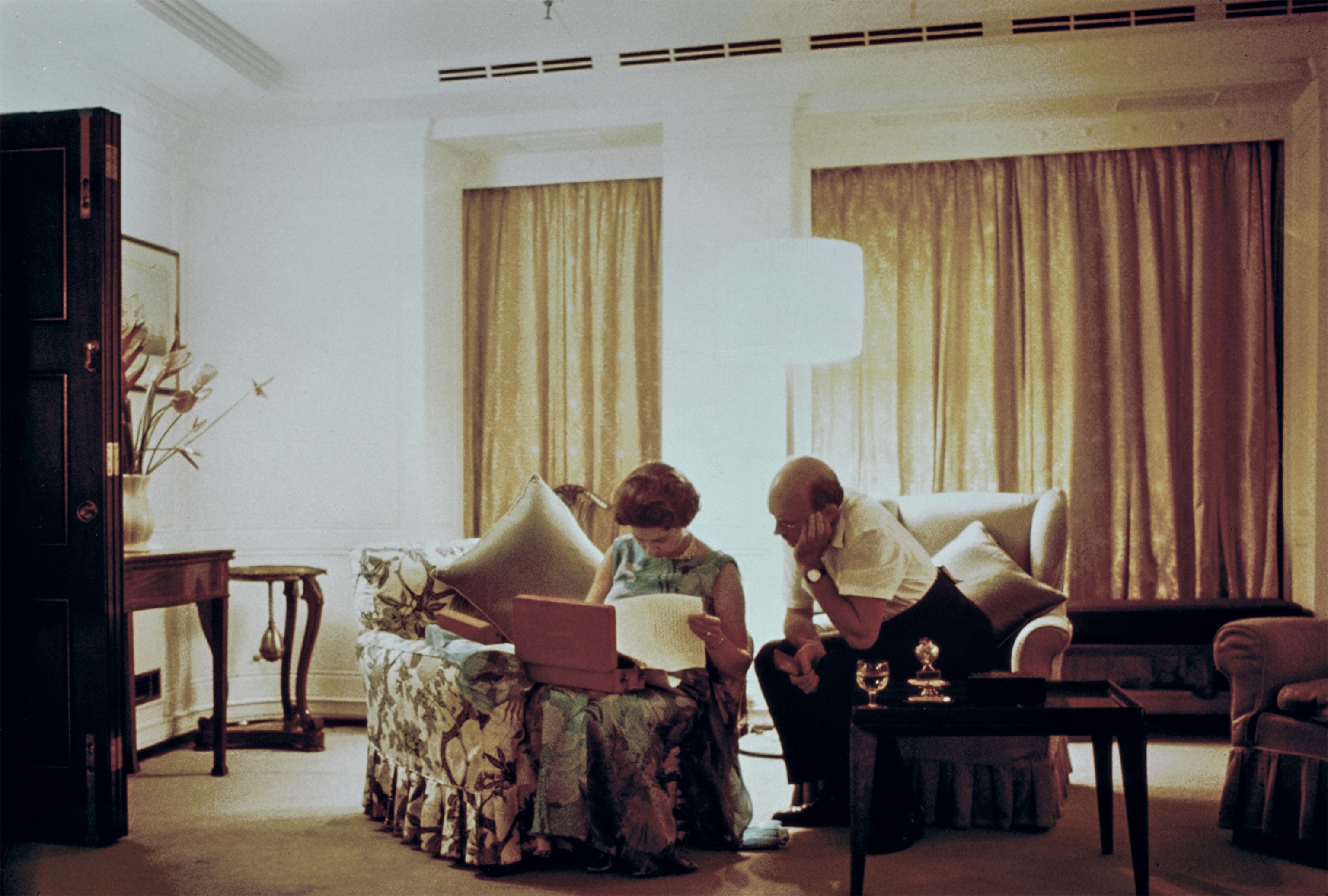The queen works late at night with her private secretary in 1972 aboard her luxury yacht Britannia.