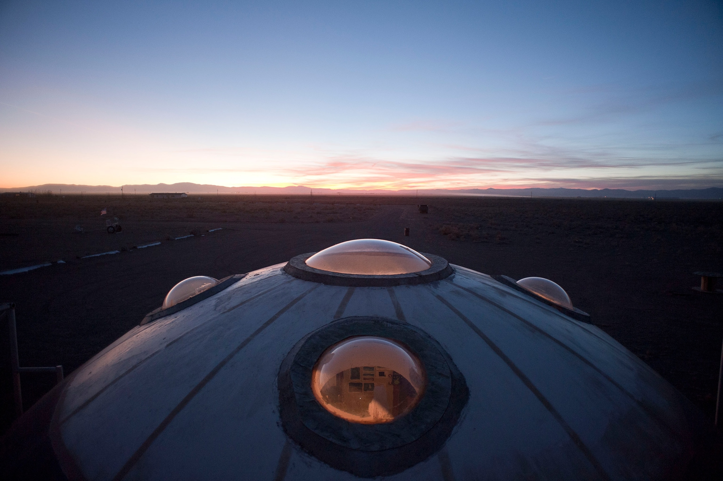 A sunset behind the alien watch tower under the blue sky.