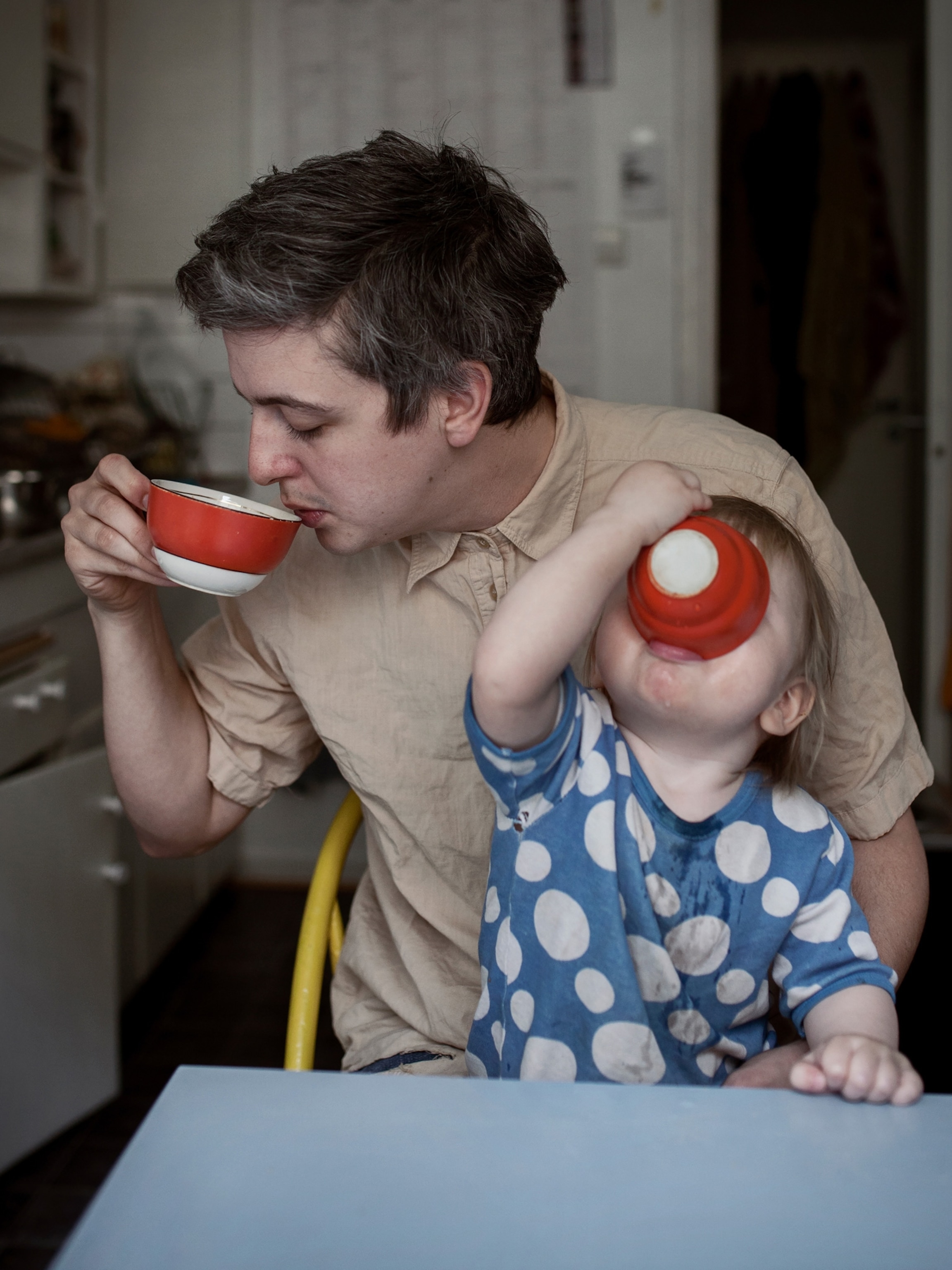 a father with his child drinking out of a cup