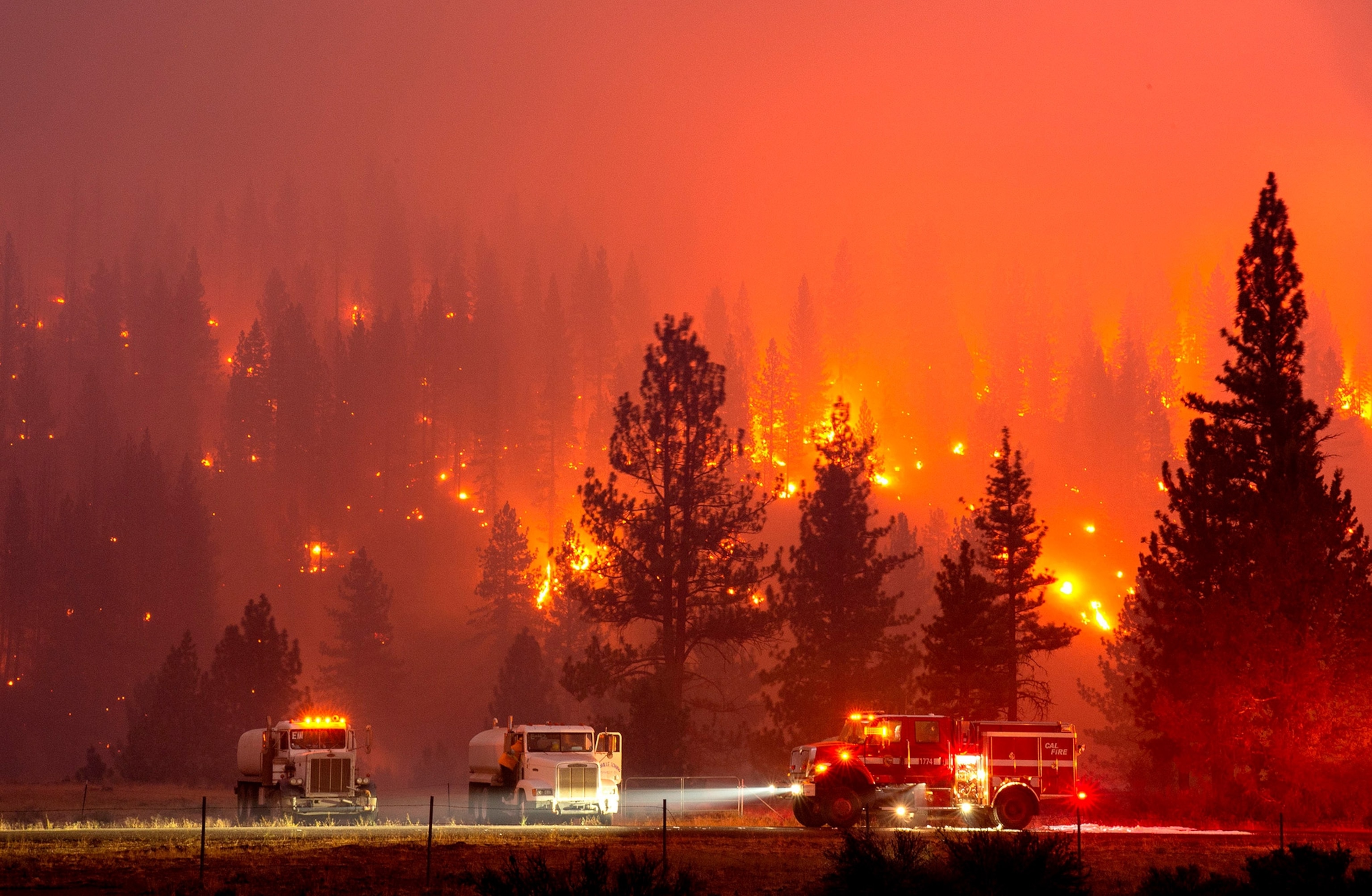 a long exposure photo of firefighters mopping up hot spots in the Hog Fire in California