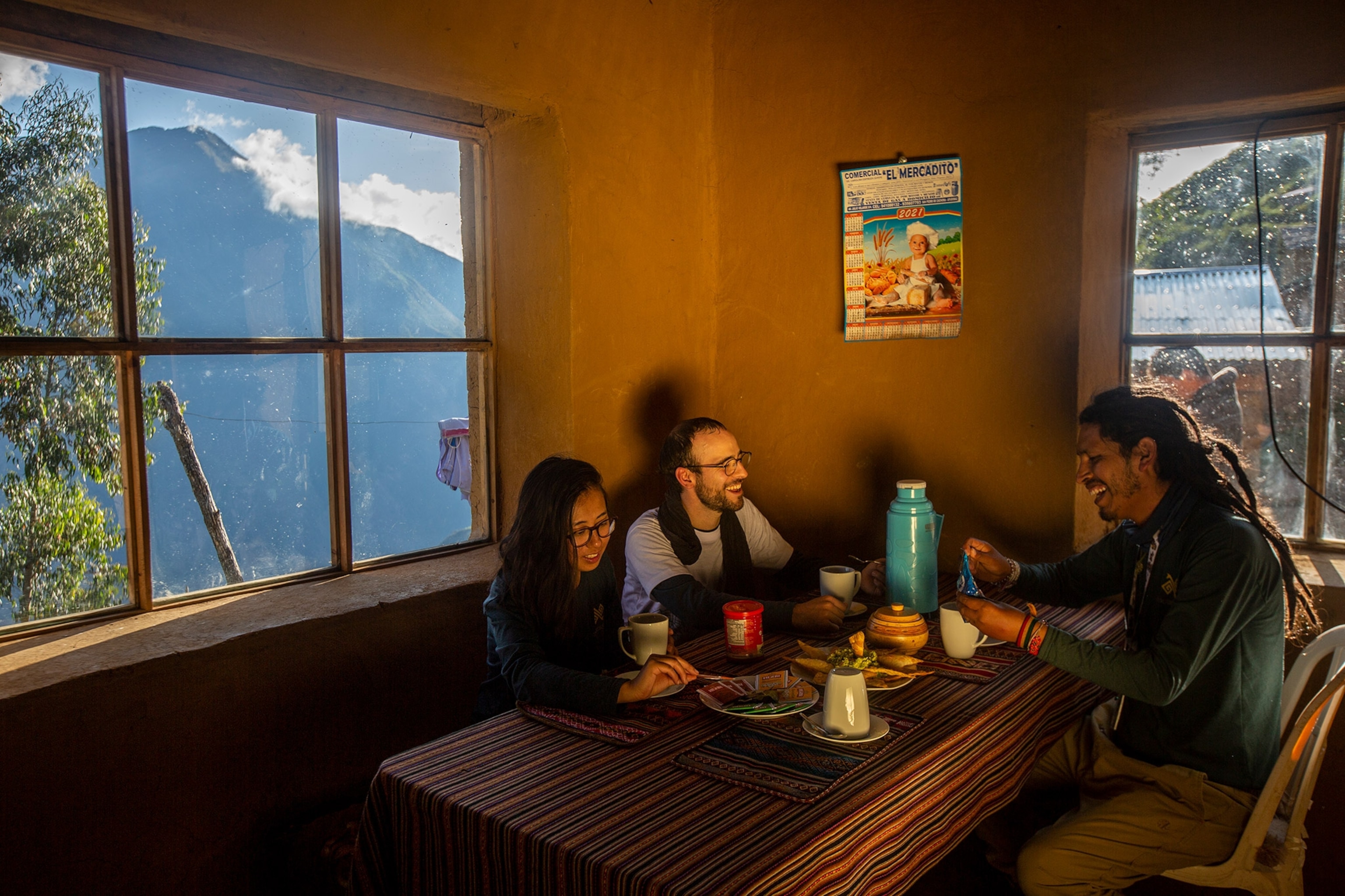 tourists enjoy a dinner with their local guide Jorge Luis Roldan at the "The orchids" camp in Marampata community