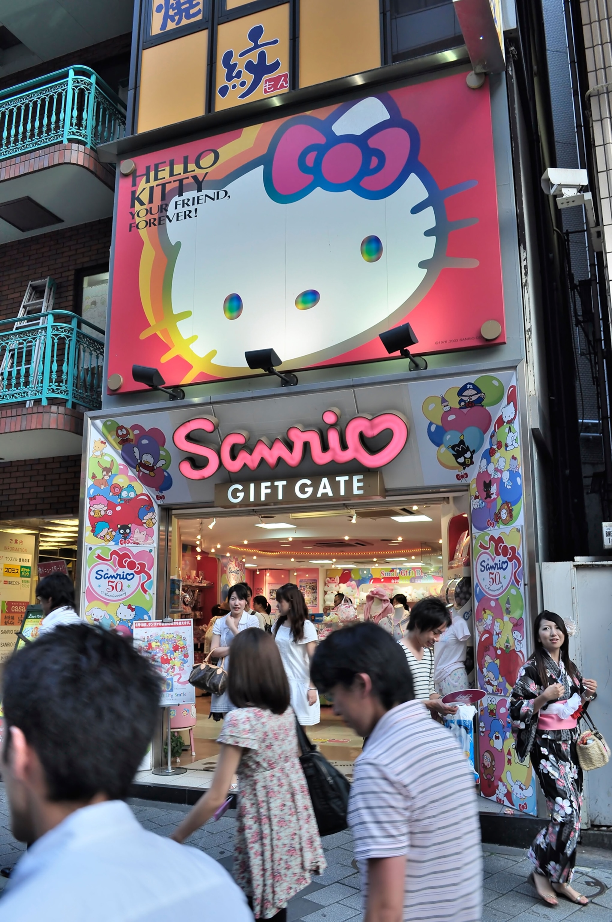 Entrance of Sanrio Hello Kitty" giftstore and Japanese girl in Kimono passing by (Tokyo, Japan)