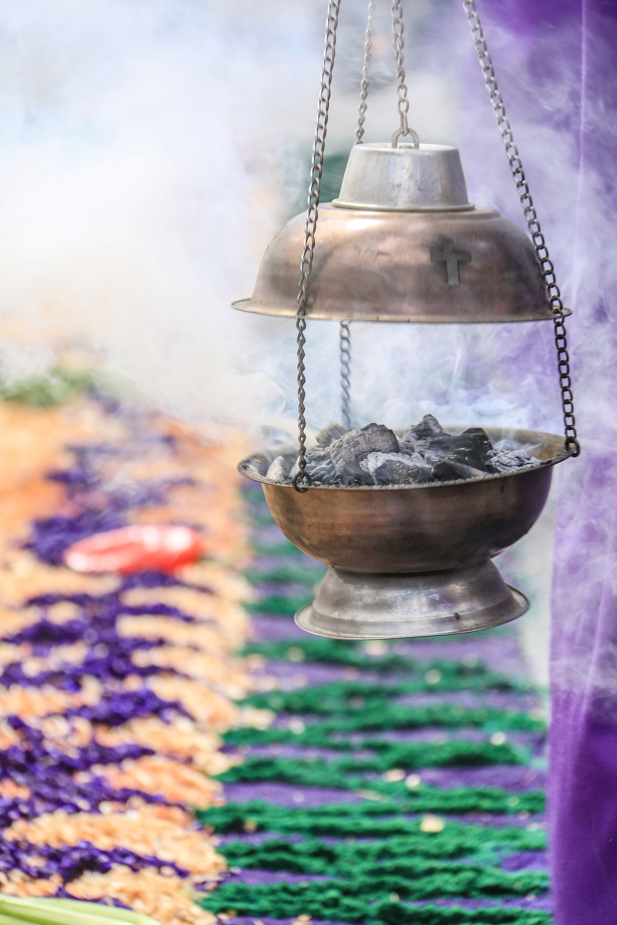 A censer disperses incence in a Semana Santa procession.