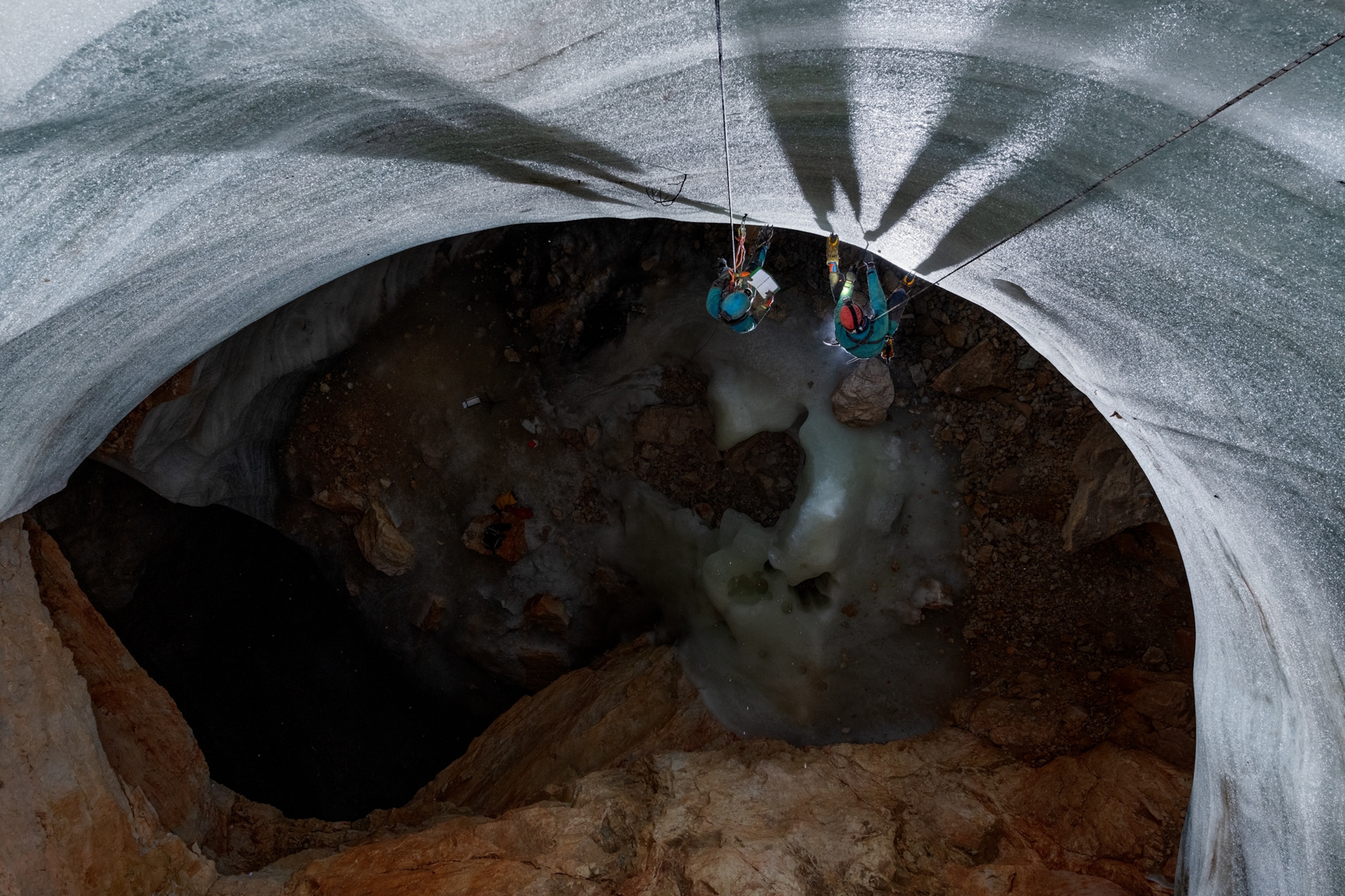 Picture of natural vertical tunnel in ice.