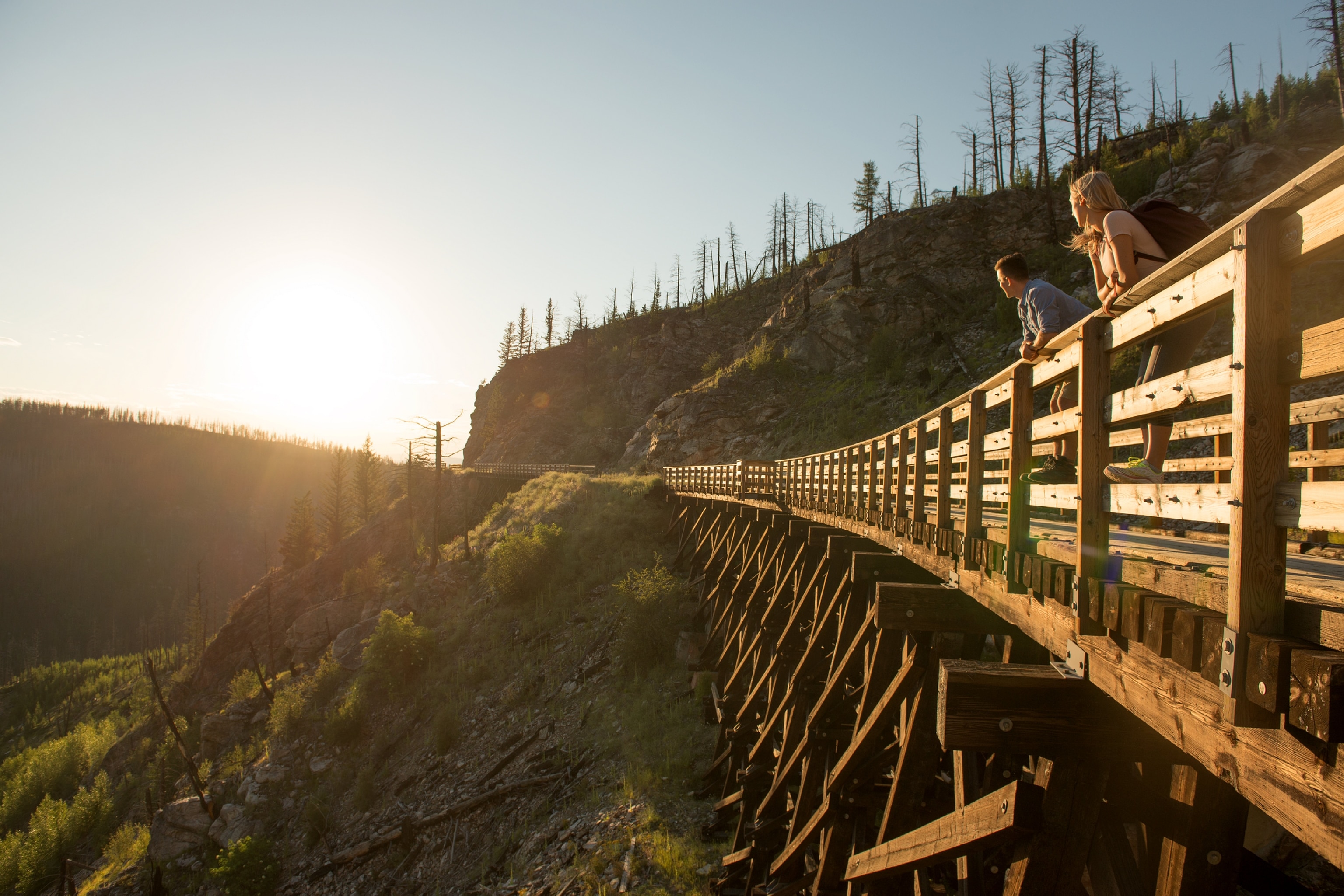 Couple enjoying the sunset overlooking the Myra Canyon on the Kettle Valley Rail Trail