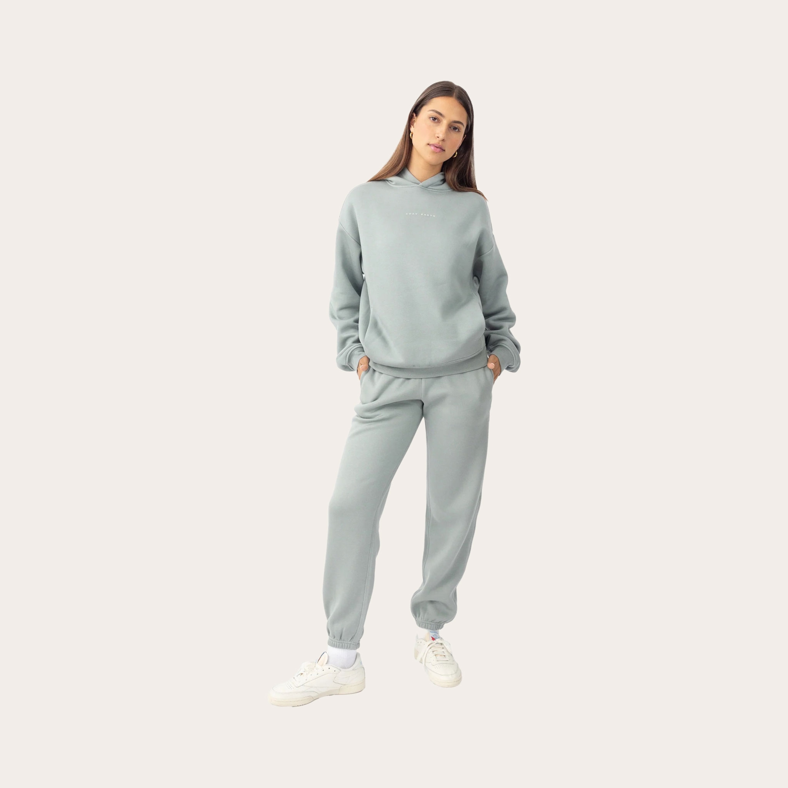 Woman wearing grey sweatpants and sweatshirt