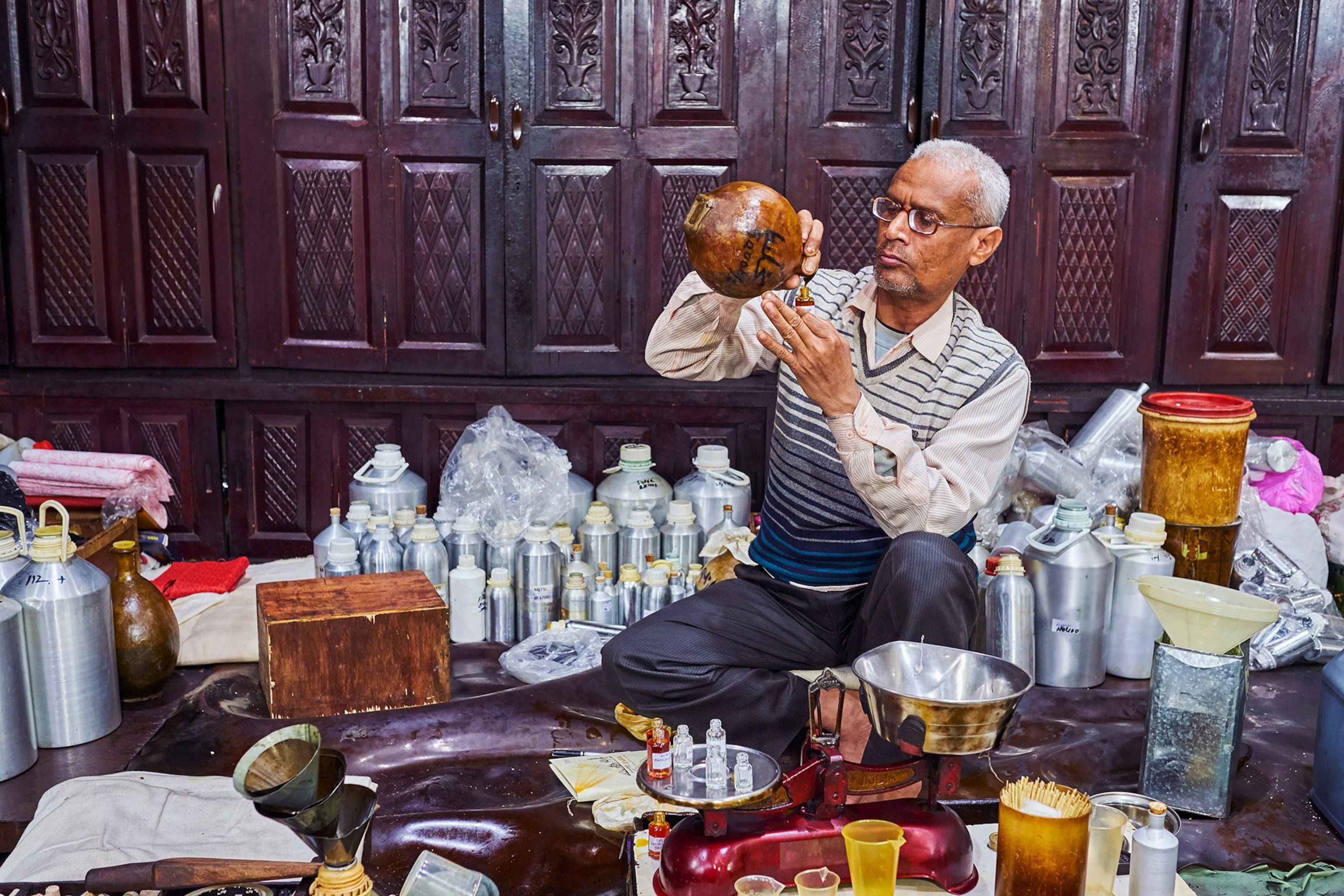 putting the rose oil fragrance into a camel skin gourd