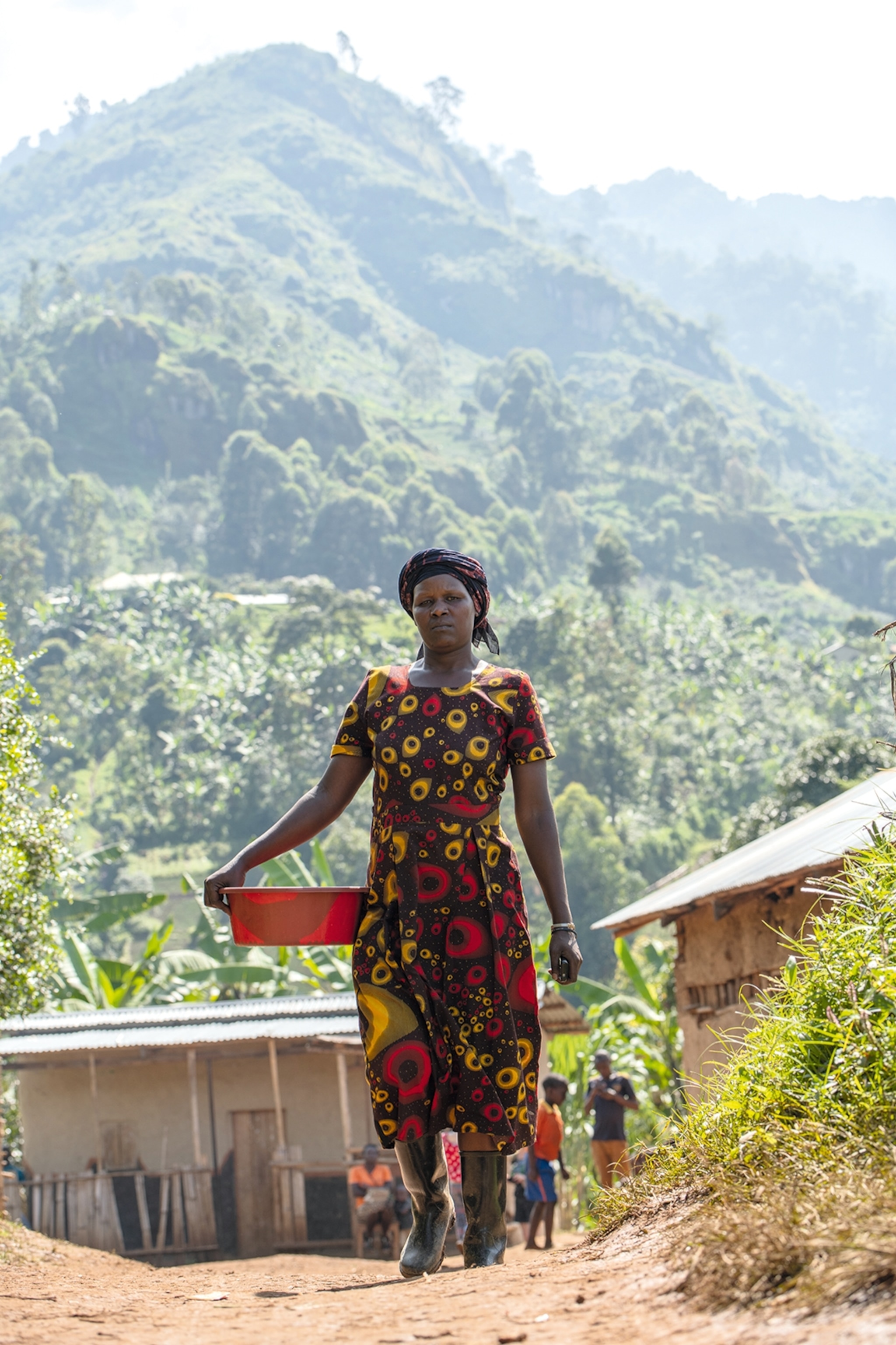A woman holding a red bucket