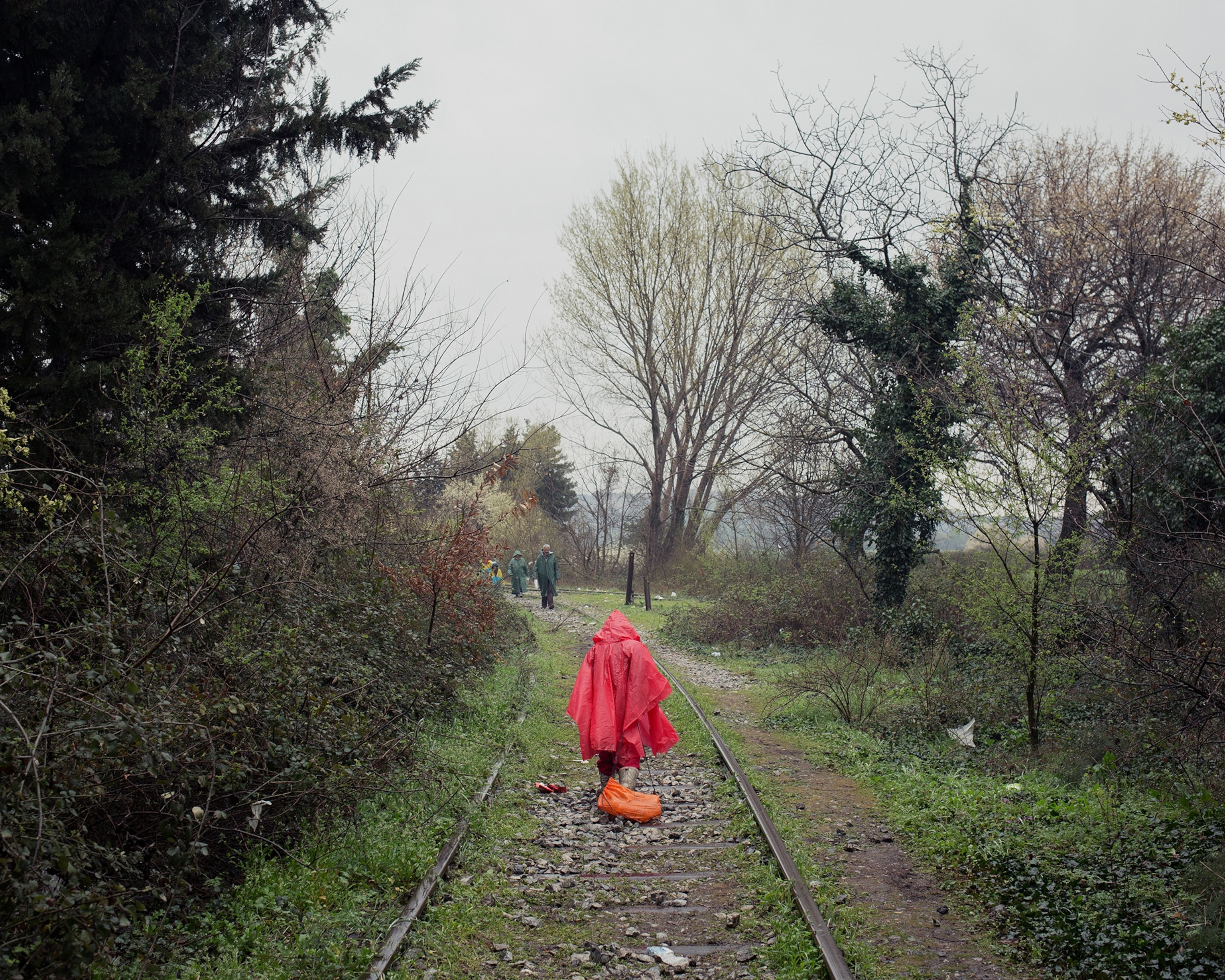 people walking on railroad track