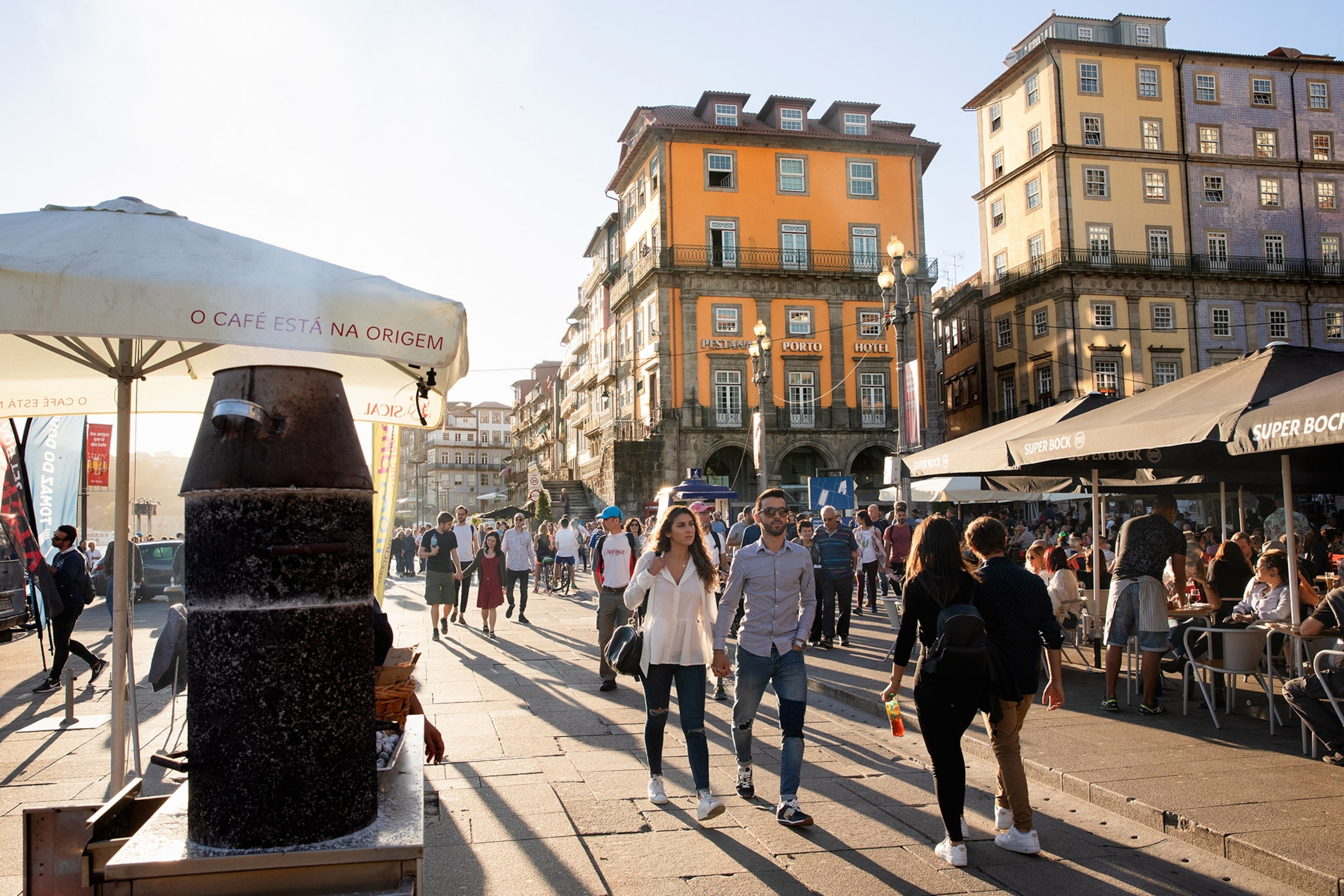 waterfront promenade in porto portugal with cafe's and pedestrians