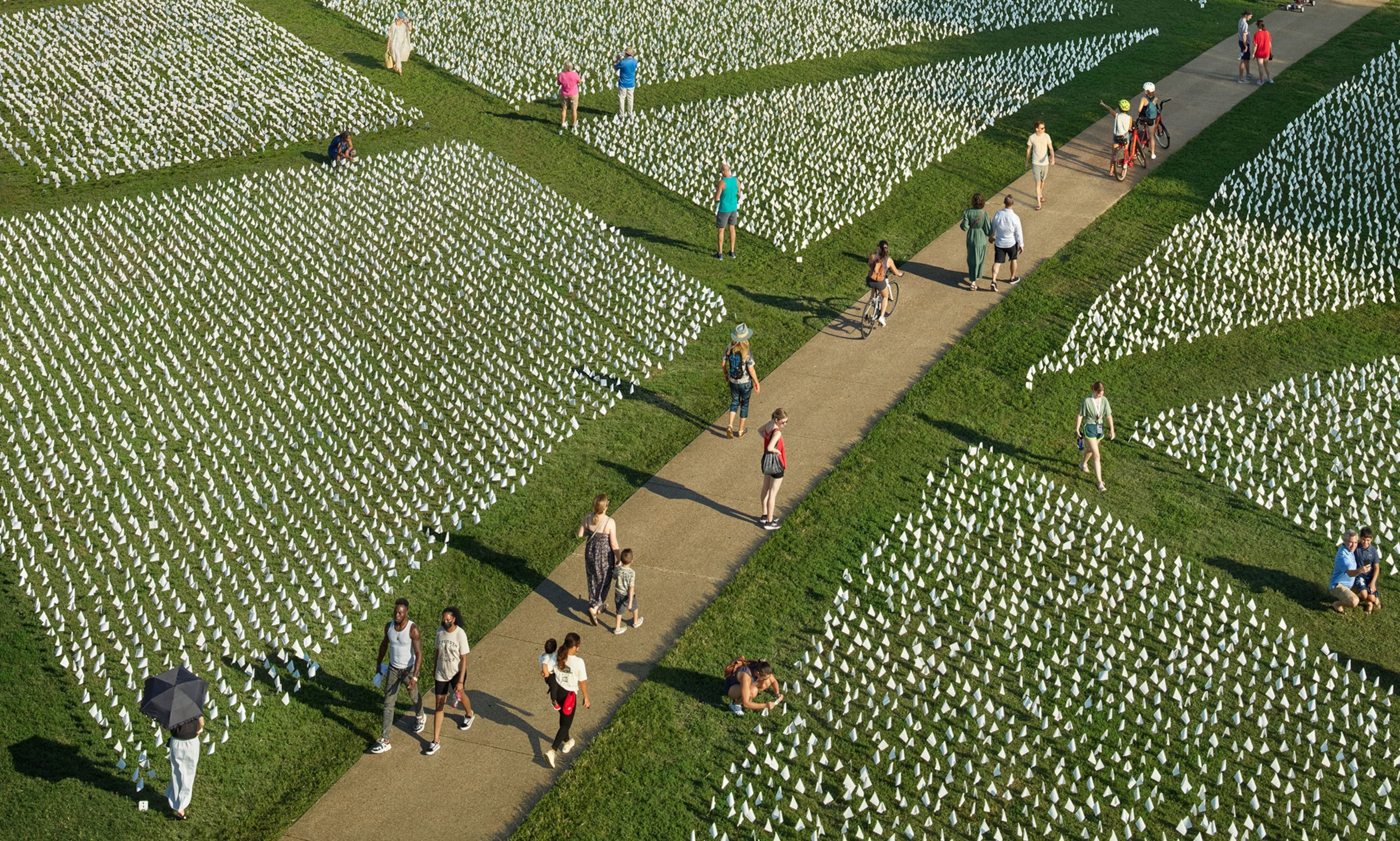 people walking near the Covid-19 memorial in Washington D.C.