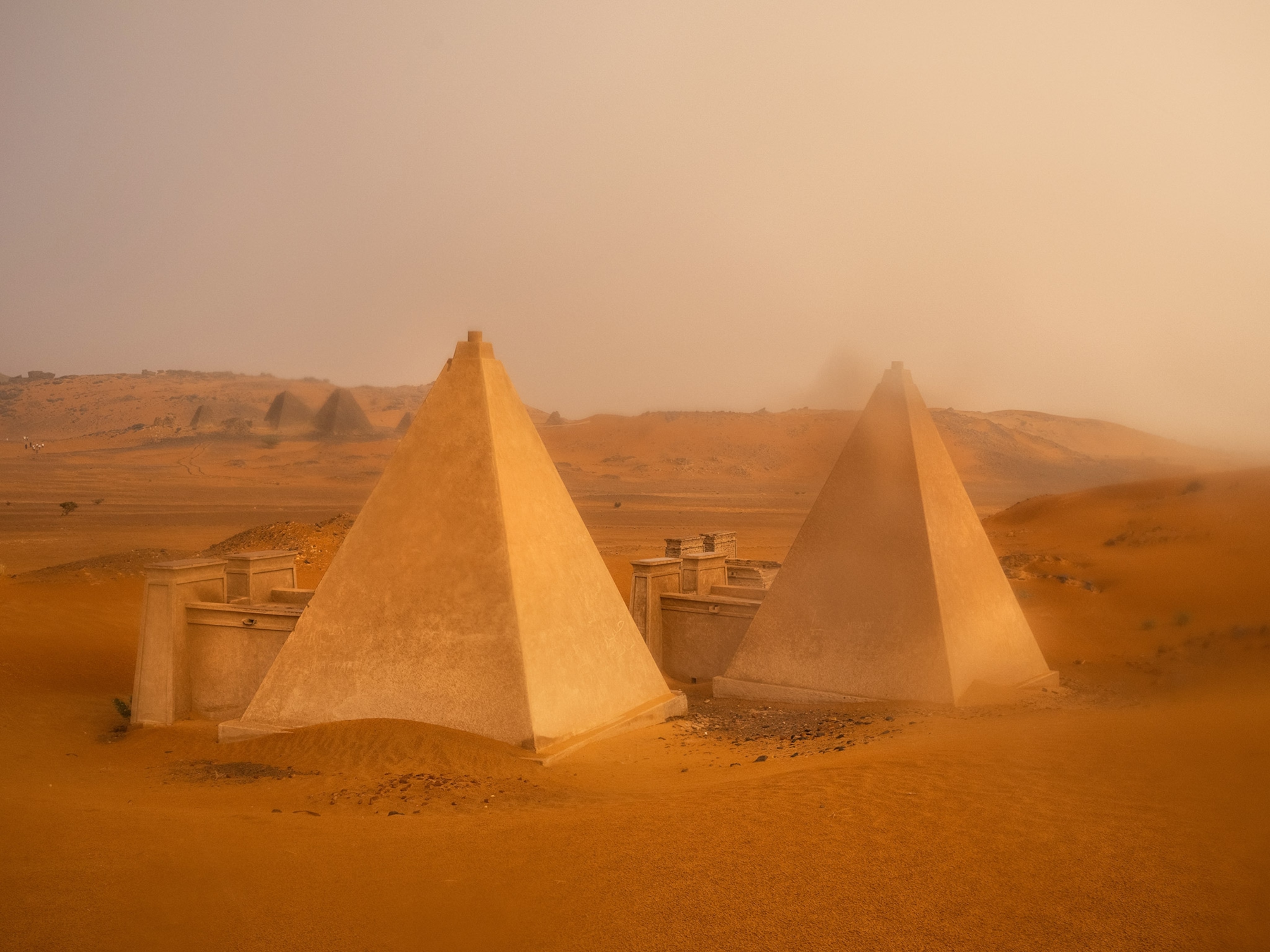 A haboob, or sandstorm, followed by a thunderstorm, rolls across the Meroë pyramids, Sudan