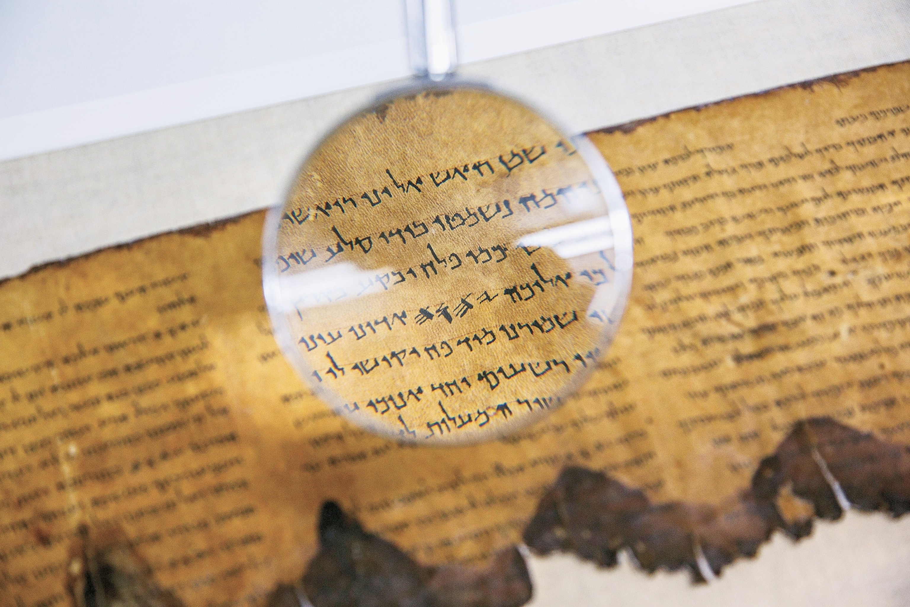 A conservation analyst from the Israel Antiquities Authority examines a fragment of the 2,000-year-old Dead Sea Scrolls at a laboratory in Jerusalem.