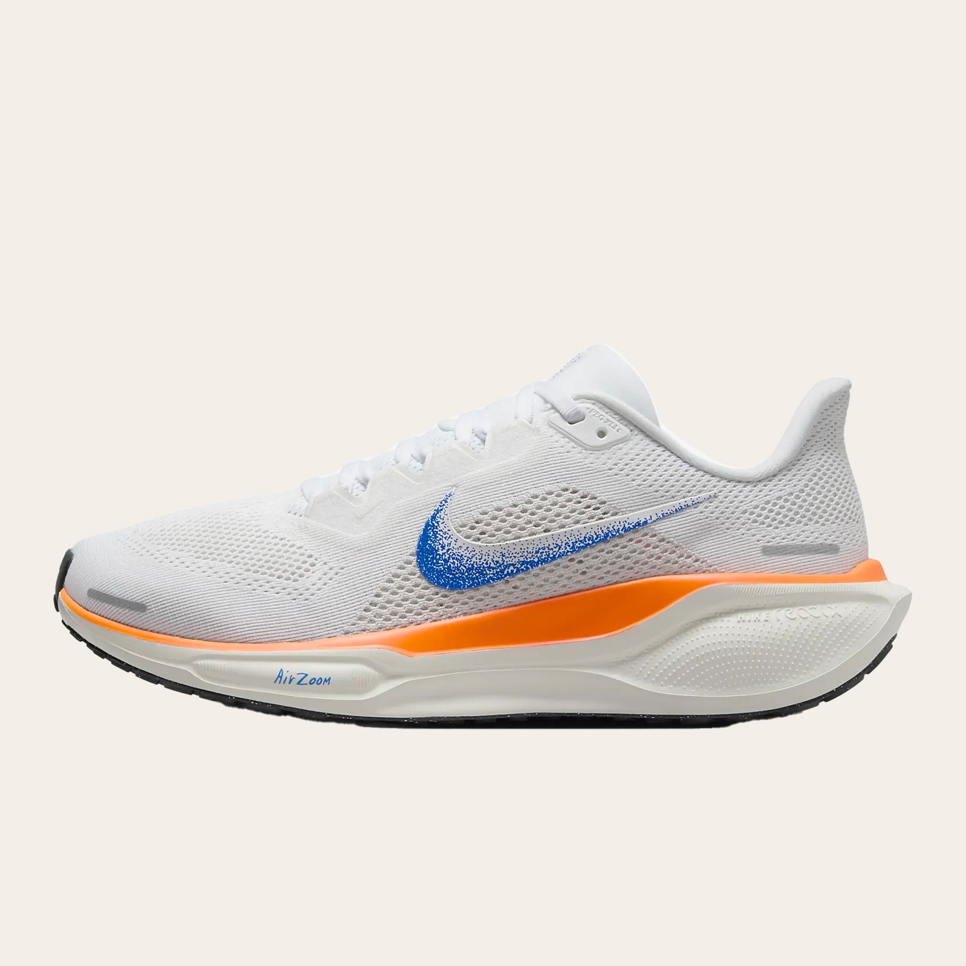 An image of white sneakers with orange accents.