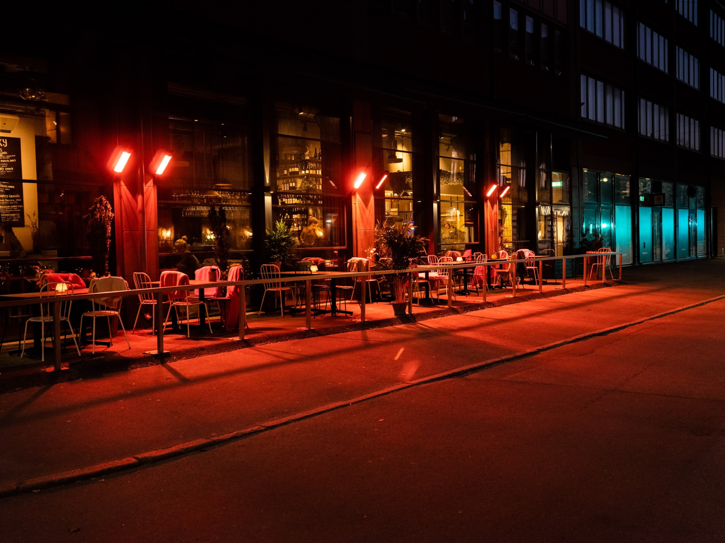 a restaurant exterior lit in red