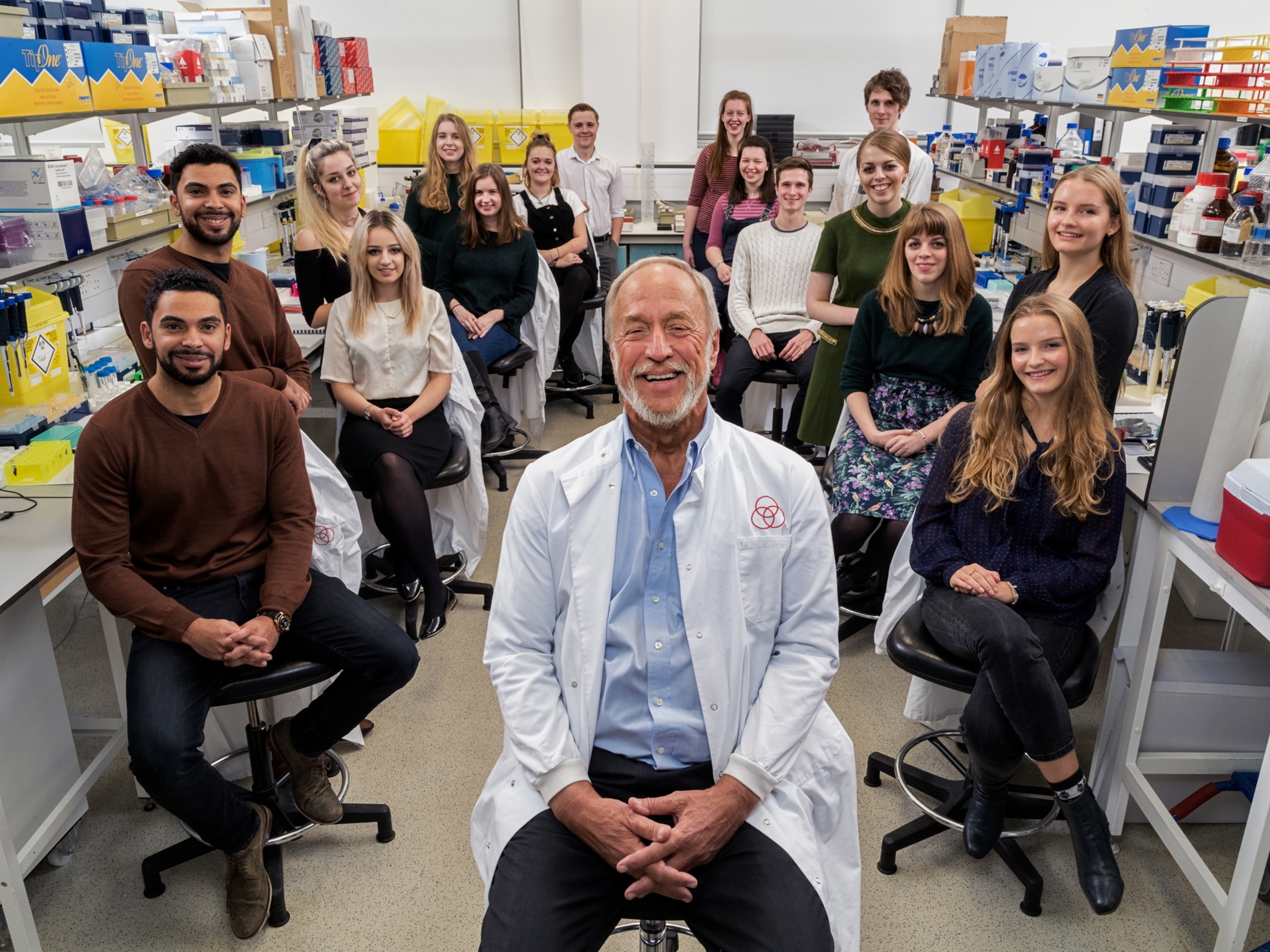 scientist in his lab with fraternal twins participants of his study.