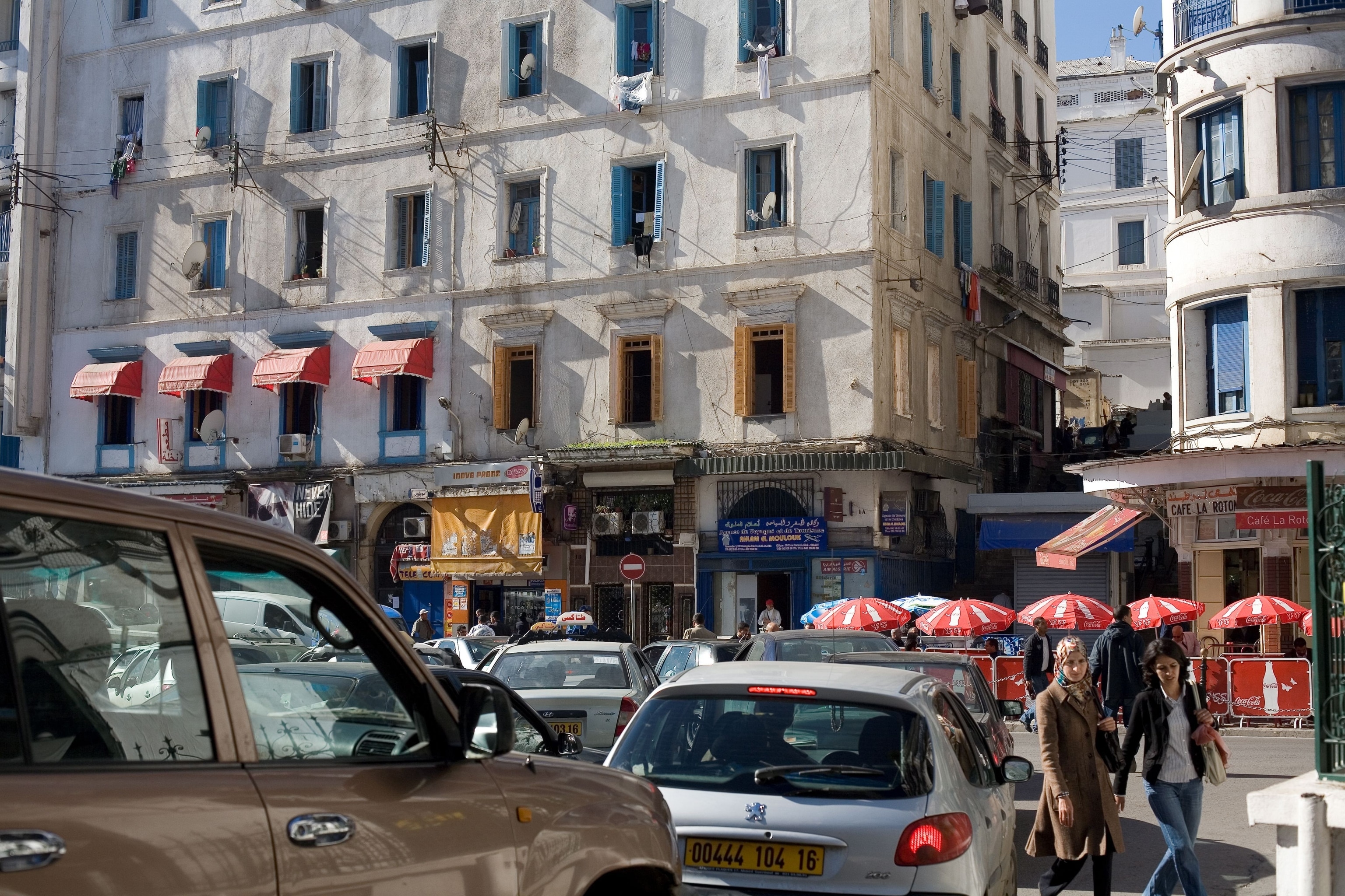 cars stand in traffic in a crowded city center