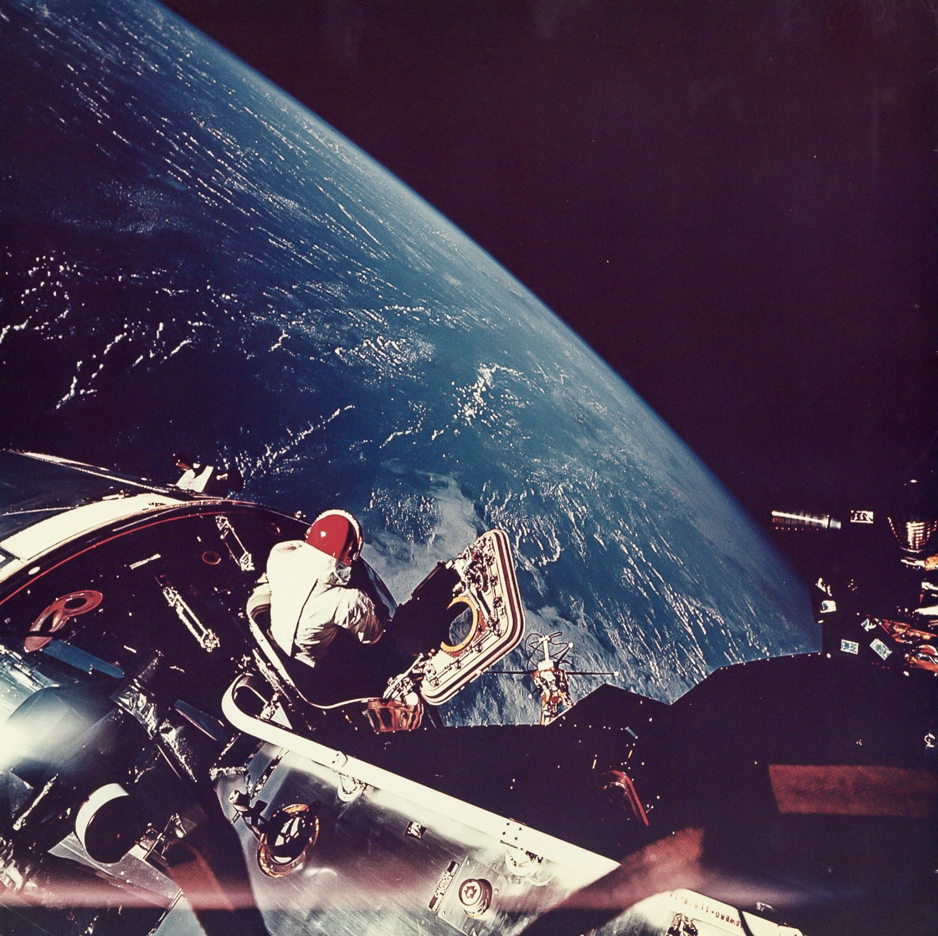 astronaut David Scott looking at Earth from Apollo 9
