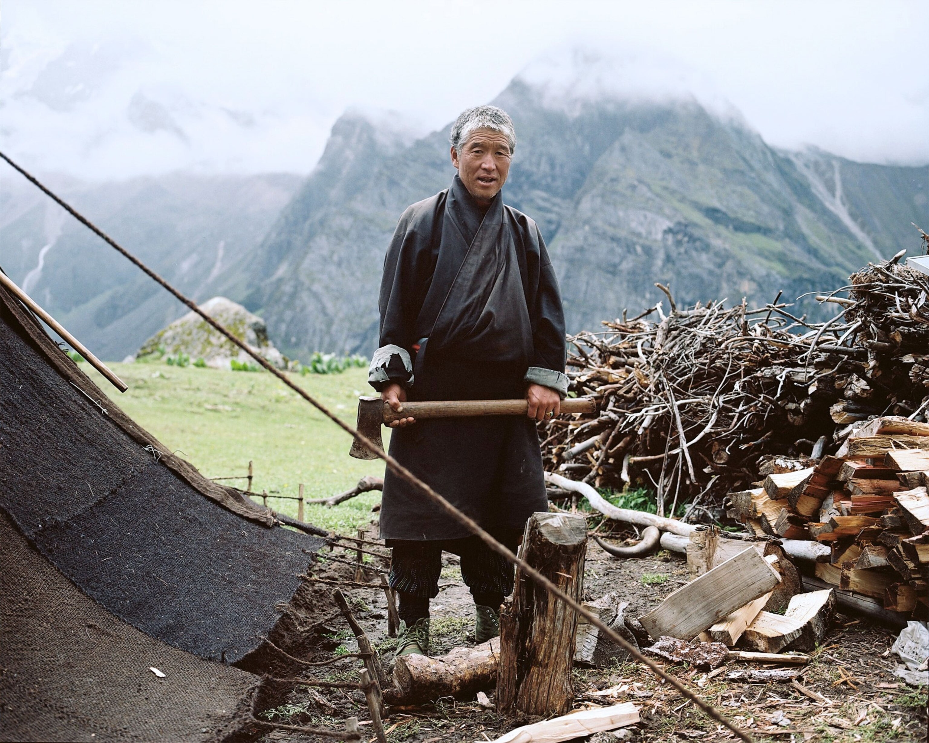 a man chopping wood in the mountains of Bhutan