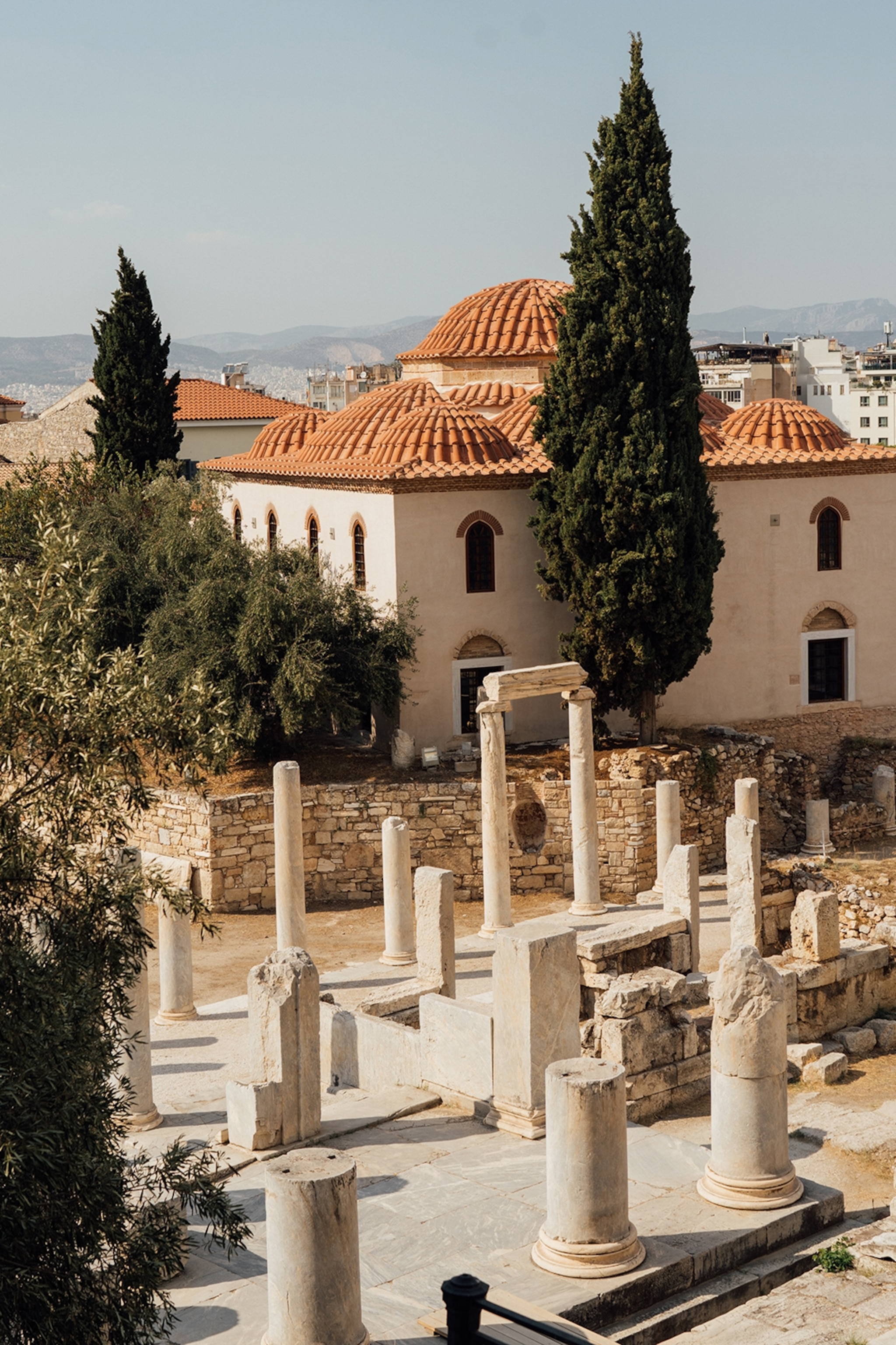 Ancient colums and monuments surrounded by stone walls in an ancient city