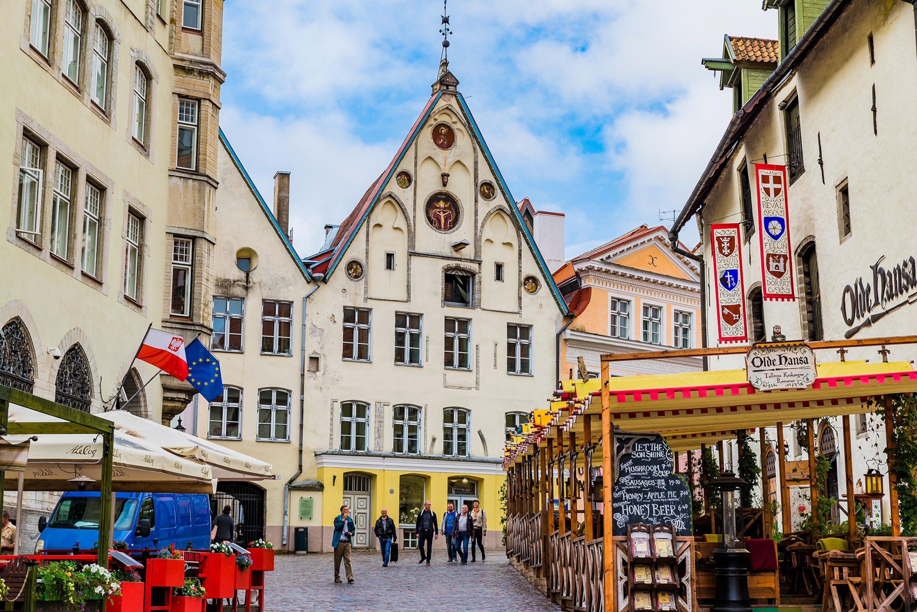 Photo of town road with people strolling.