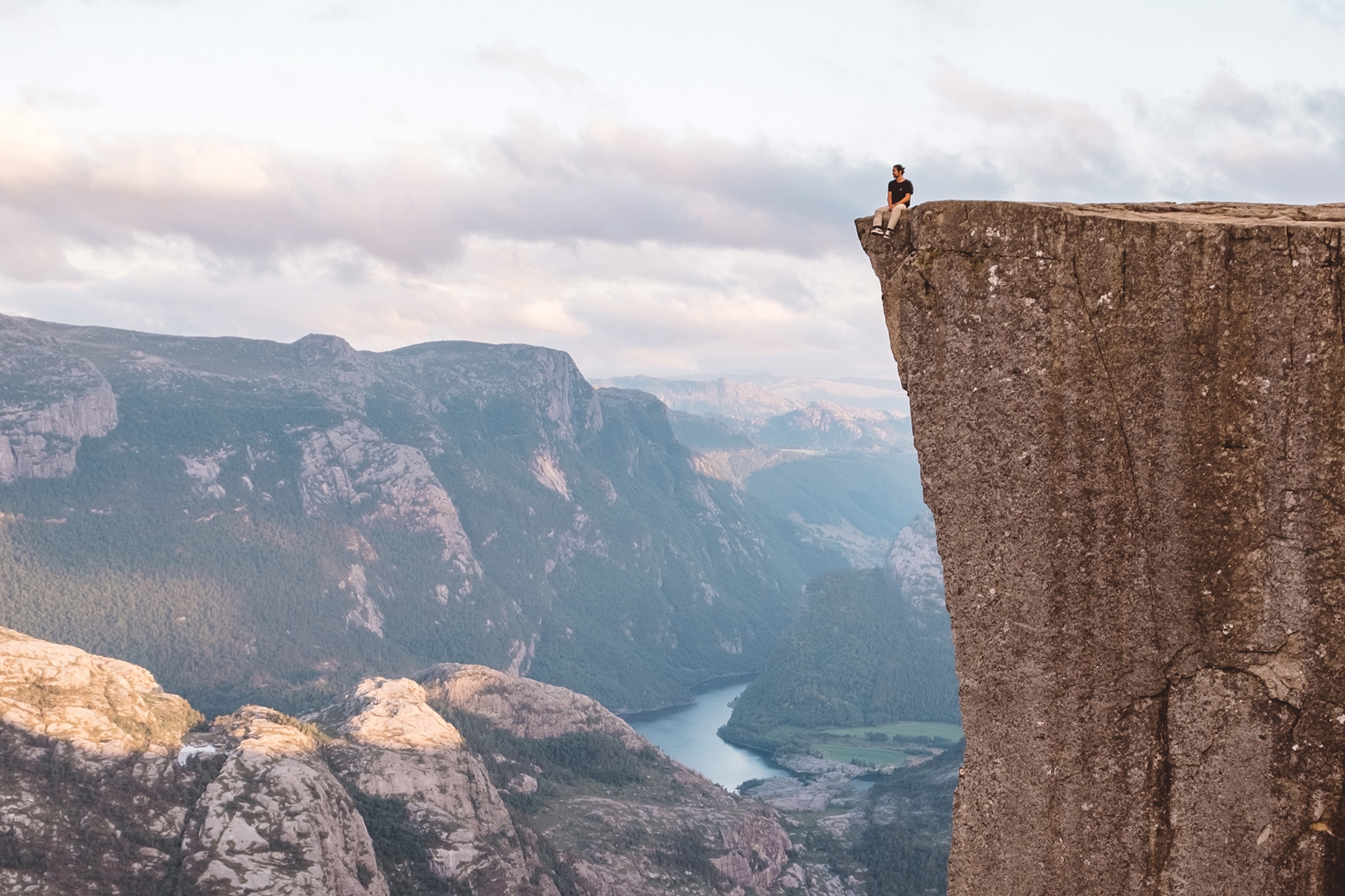 a man sitting on top of a mountain