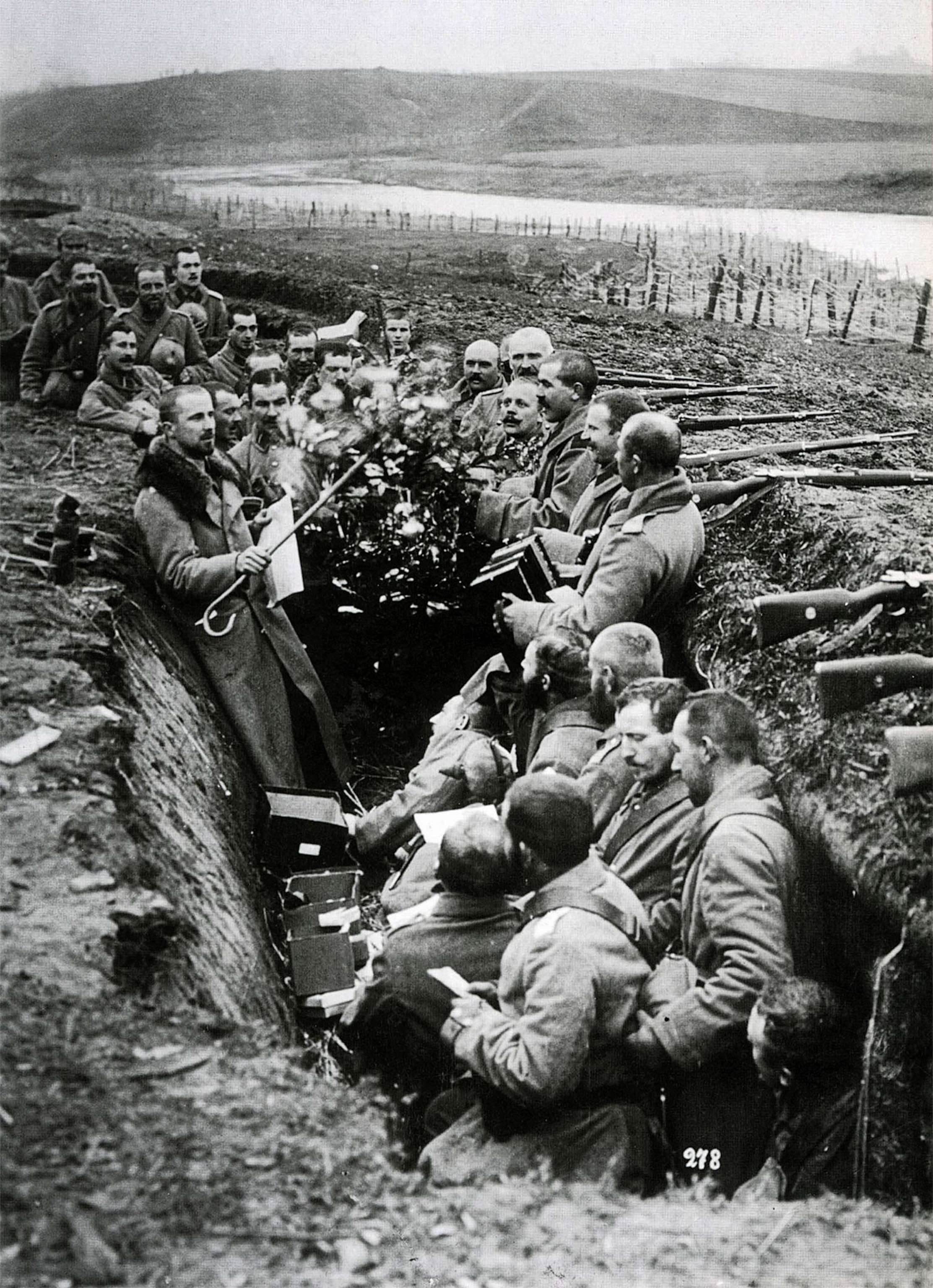 German soldiers decorate a trench with Tannenbäume, or fir trees.