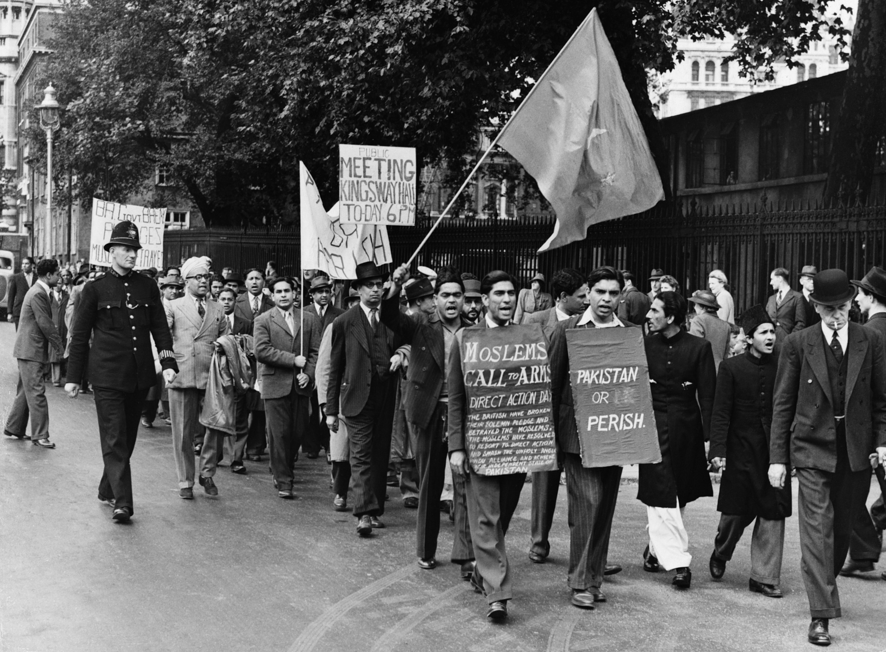 black and white photo of men marching with signs