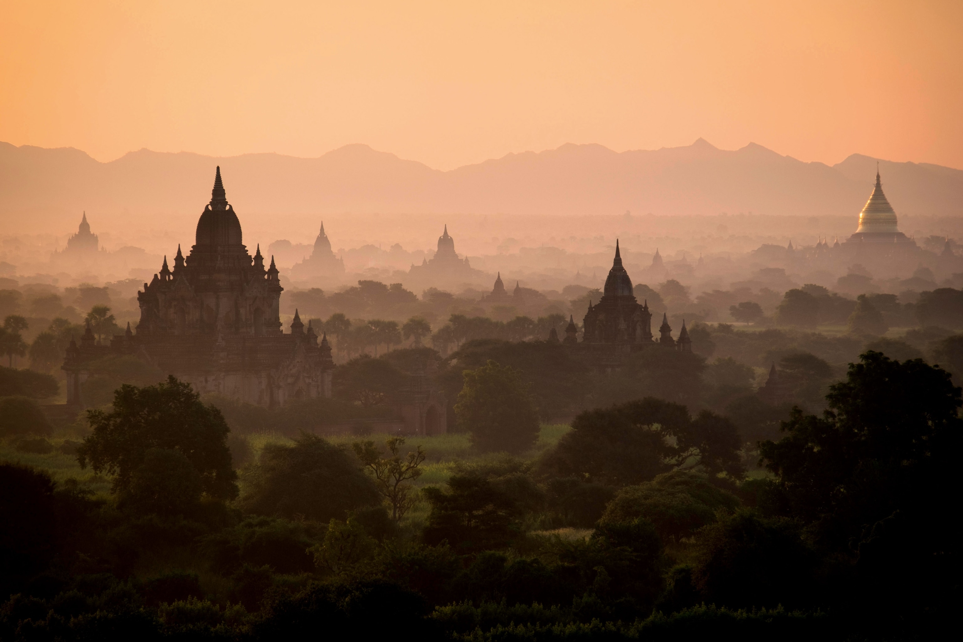 Dawn over the ancient temples in Bagan scattered through the misty landscape