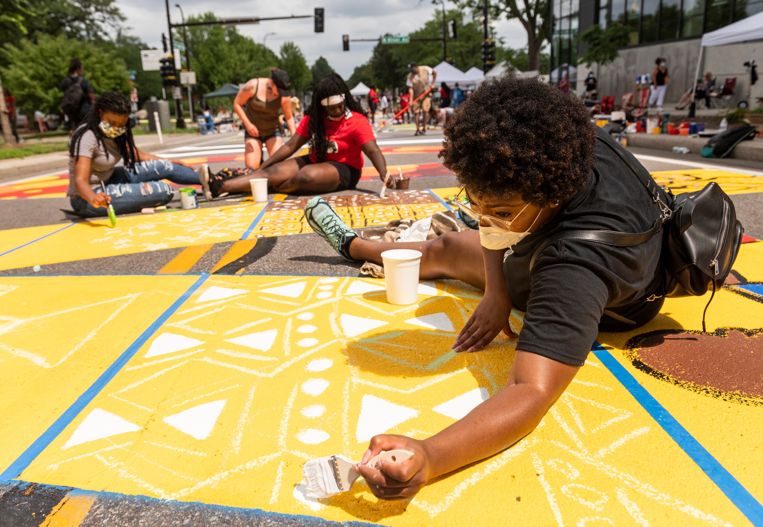 people painting a BLM mural