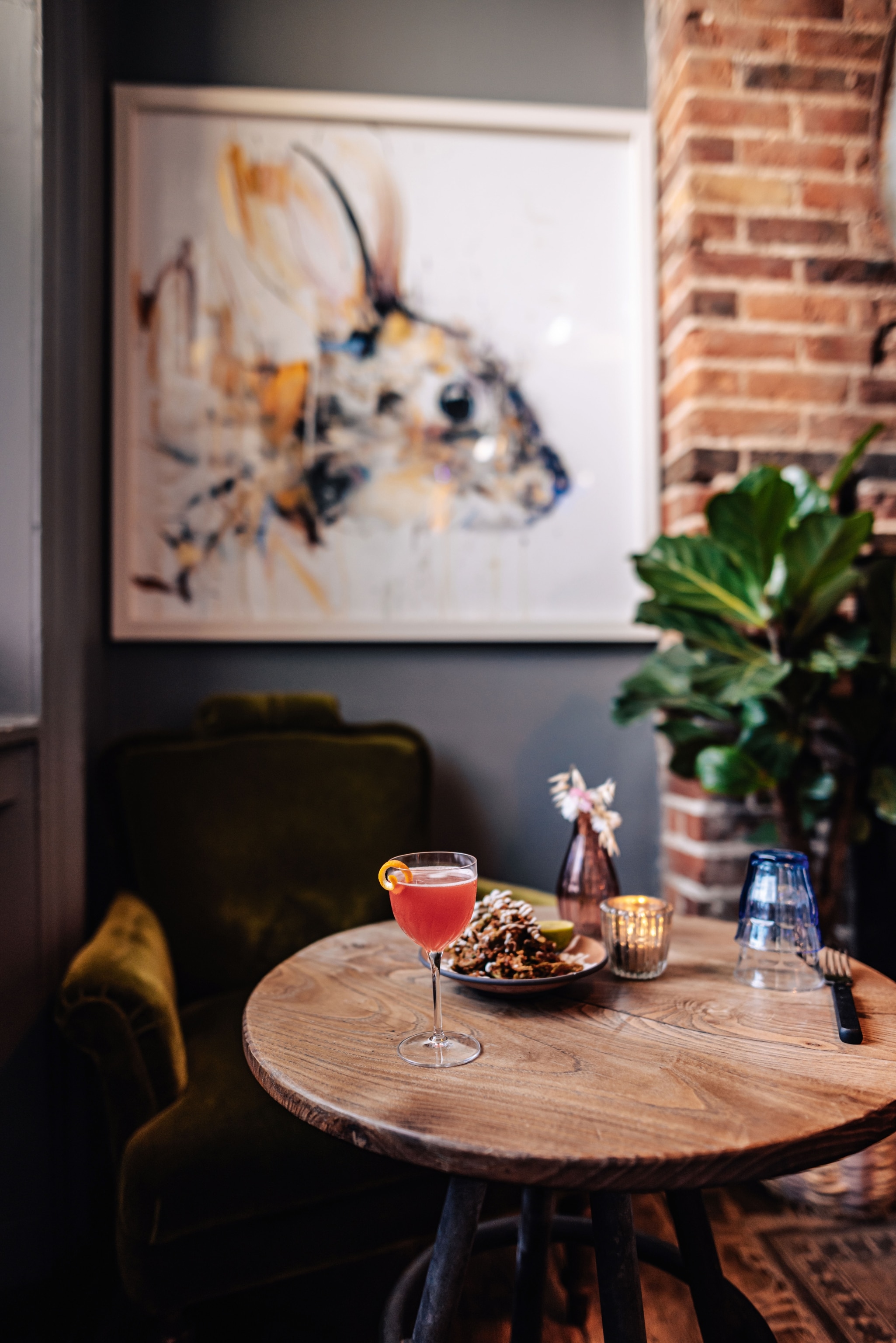 pink cocktail atop wooden table