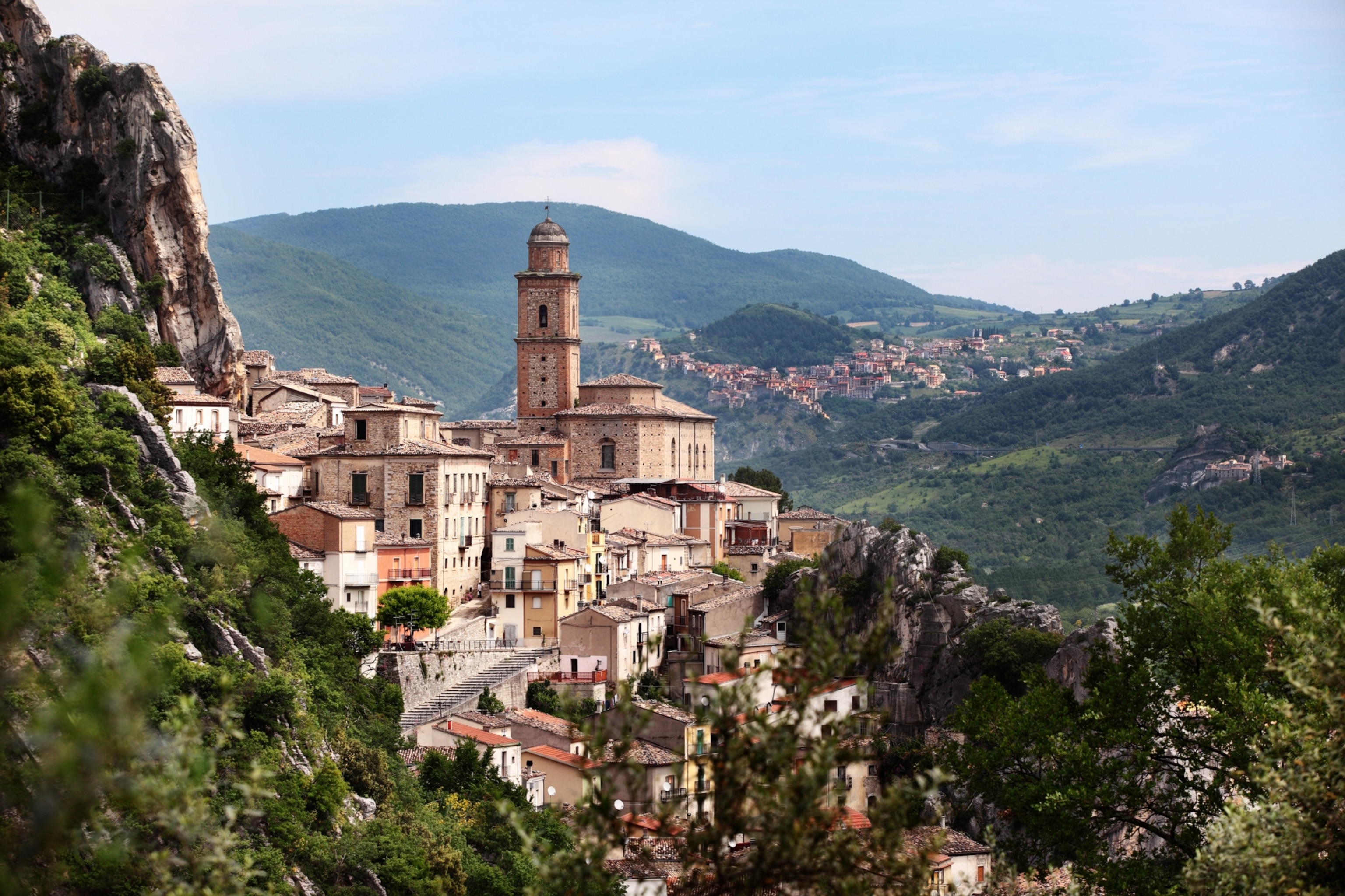 A village of stone buildings nestled in the green, mountainous terrain of Abruzzo.