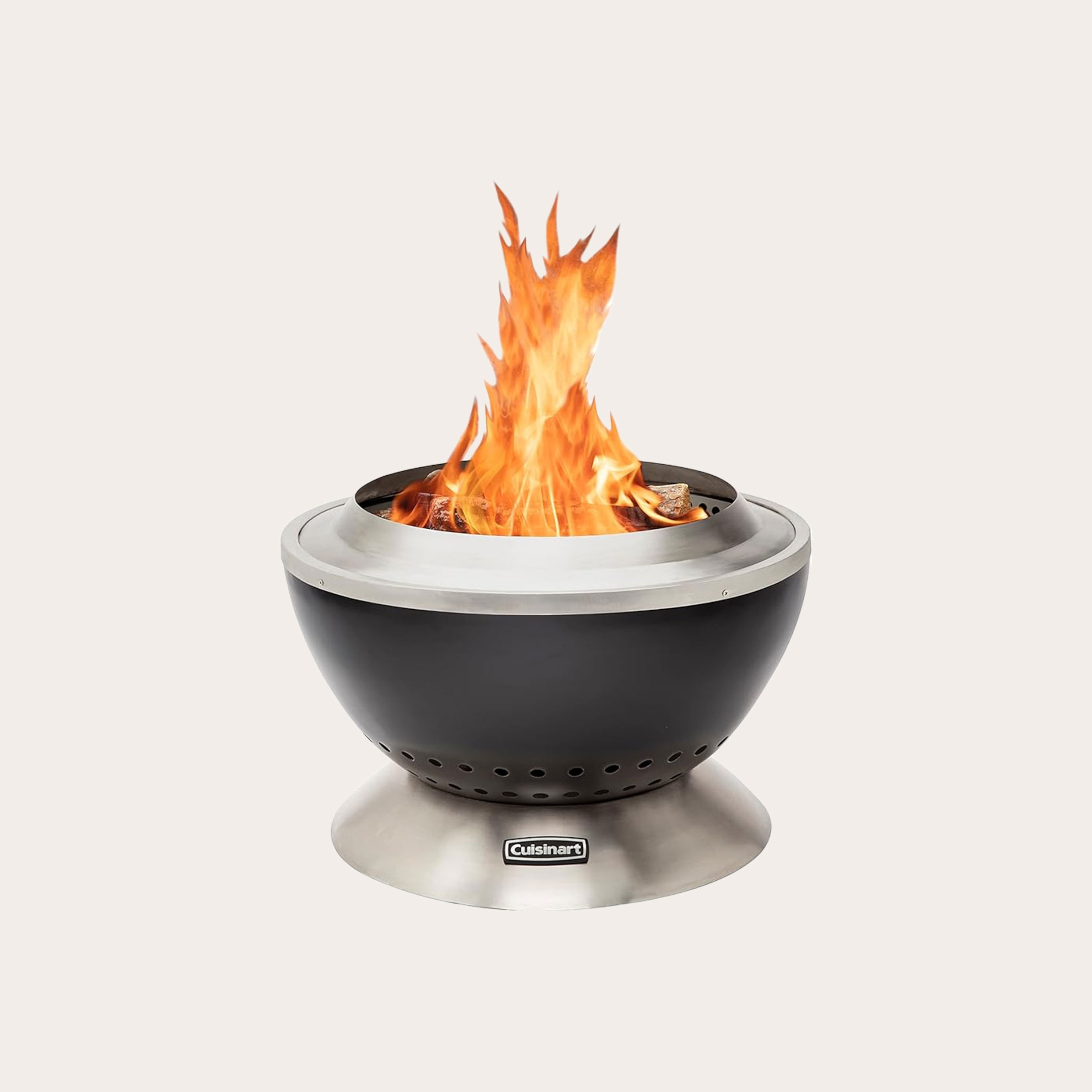 Black and silver dome-shaped fire pit with flames placed upon tan backdrop.