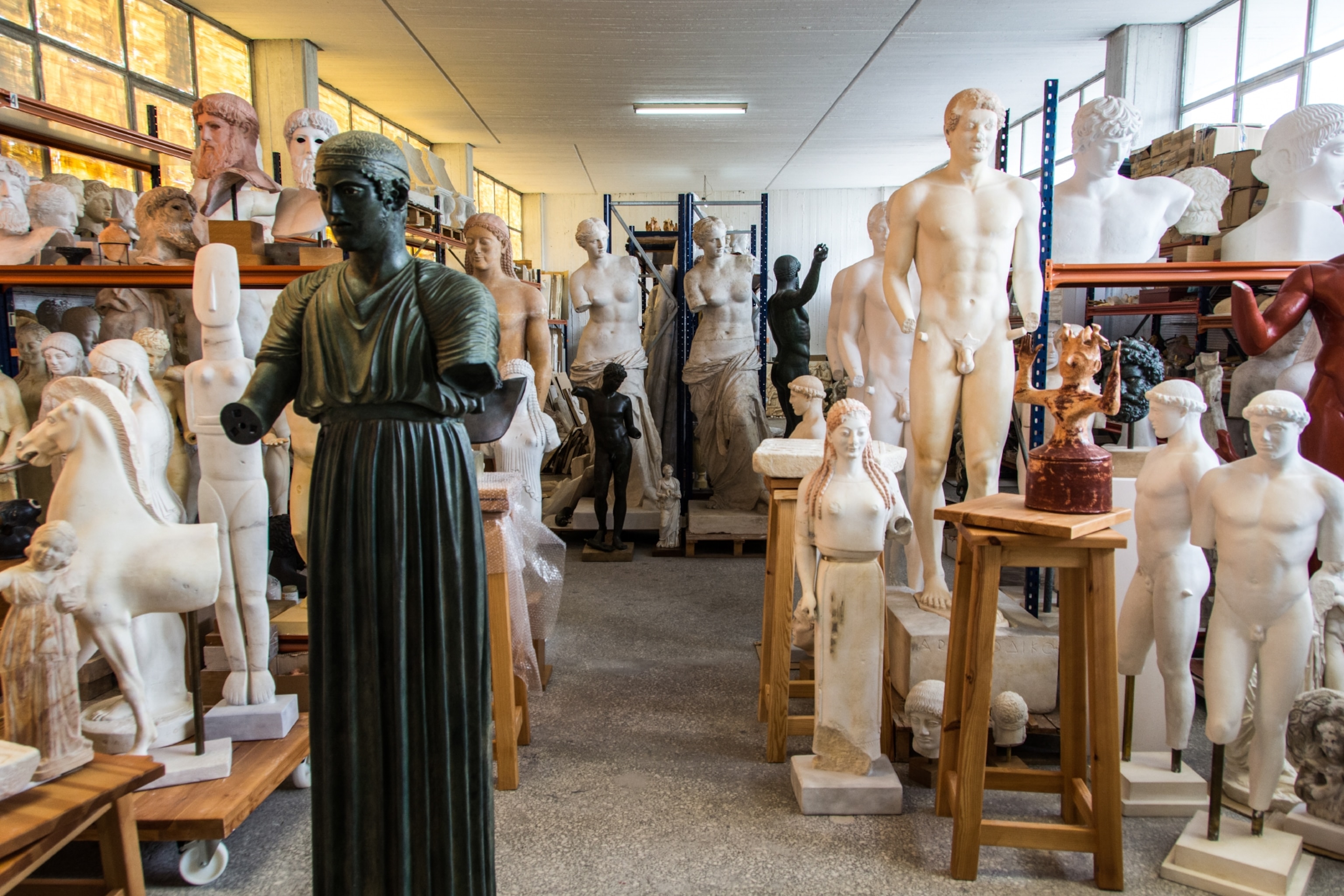 A room full of statues in various states of completion