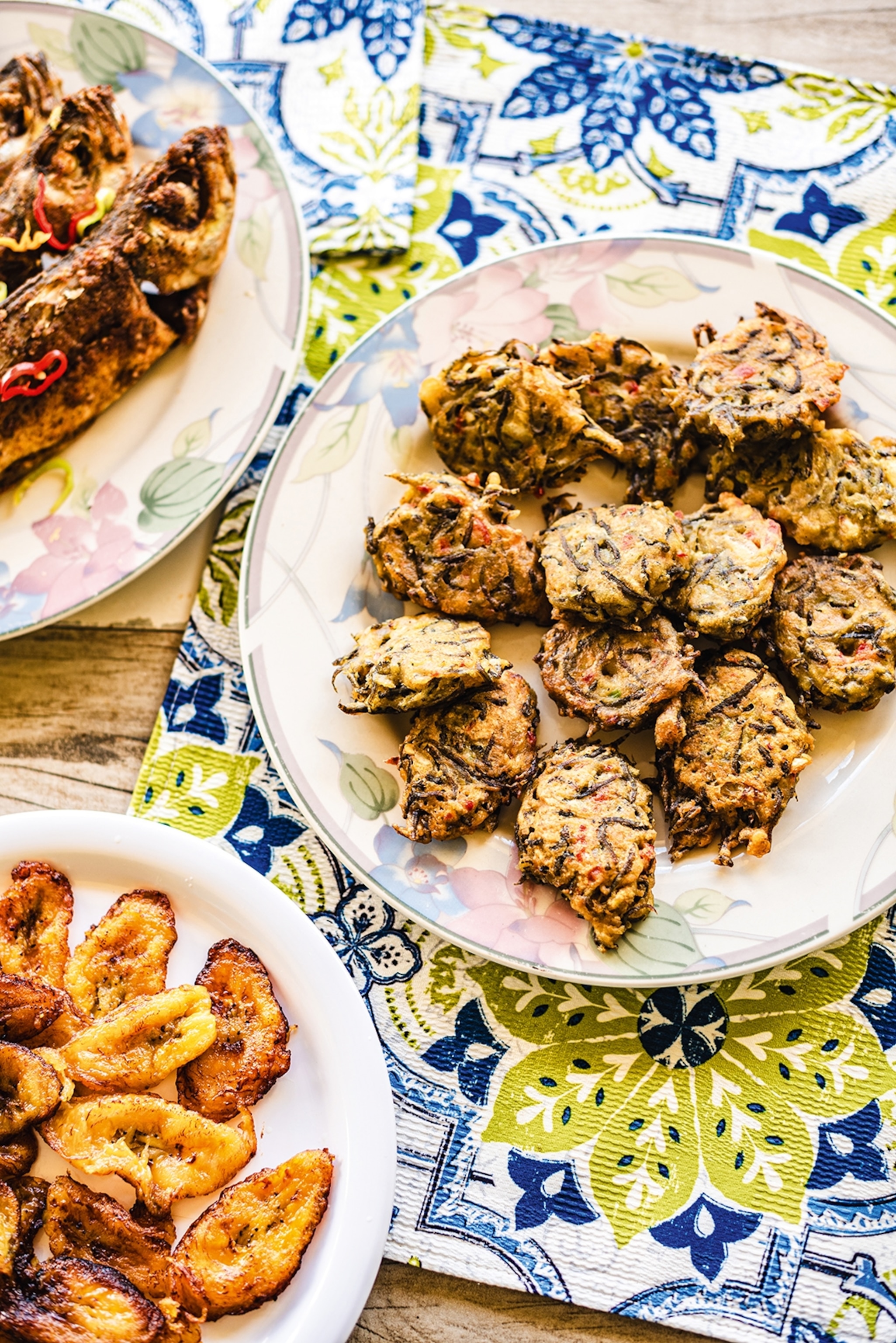 Three dishes set on a table with colourful and patterned placemats.