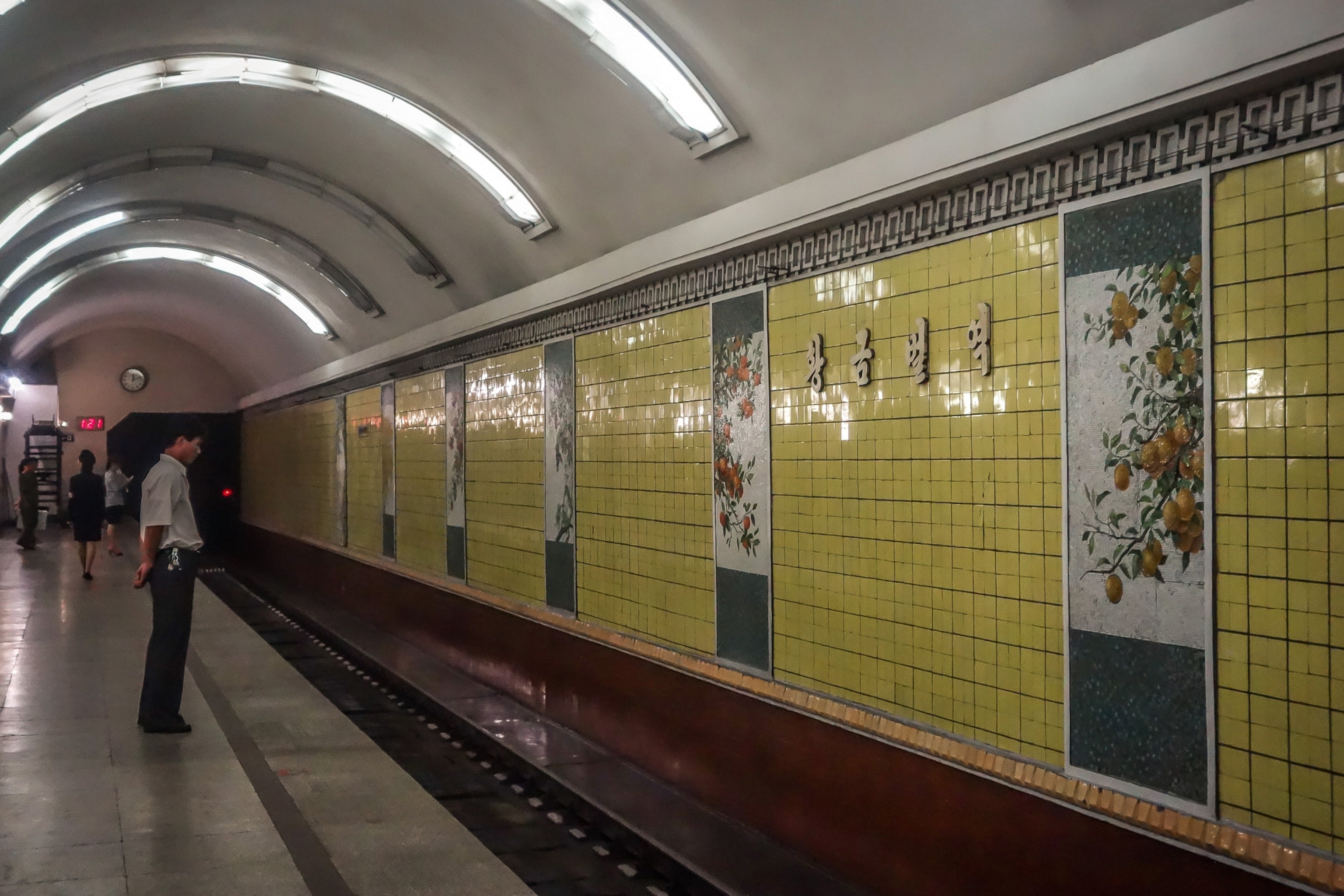 commuter standing by train tracks in Pyongyang metro