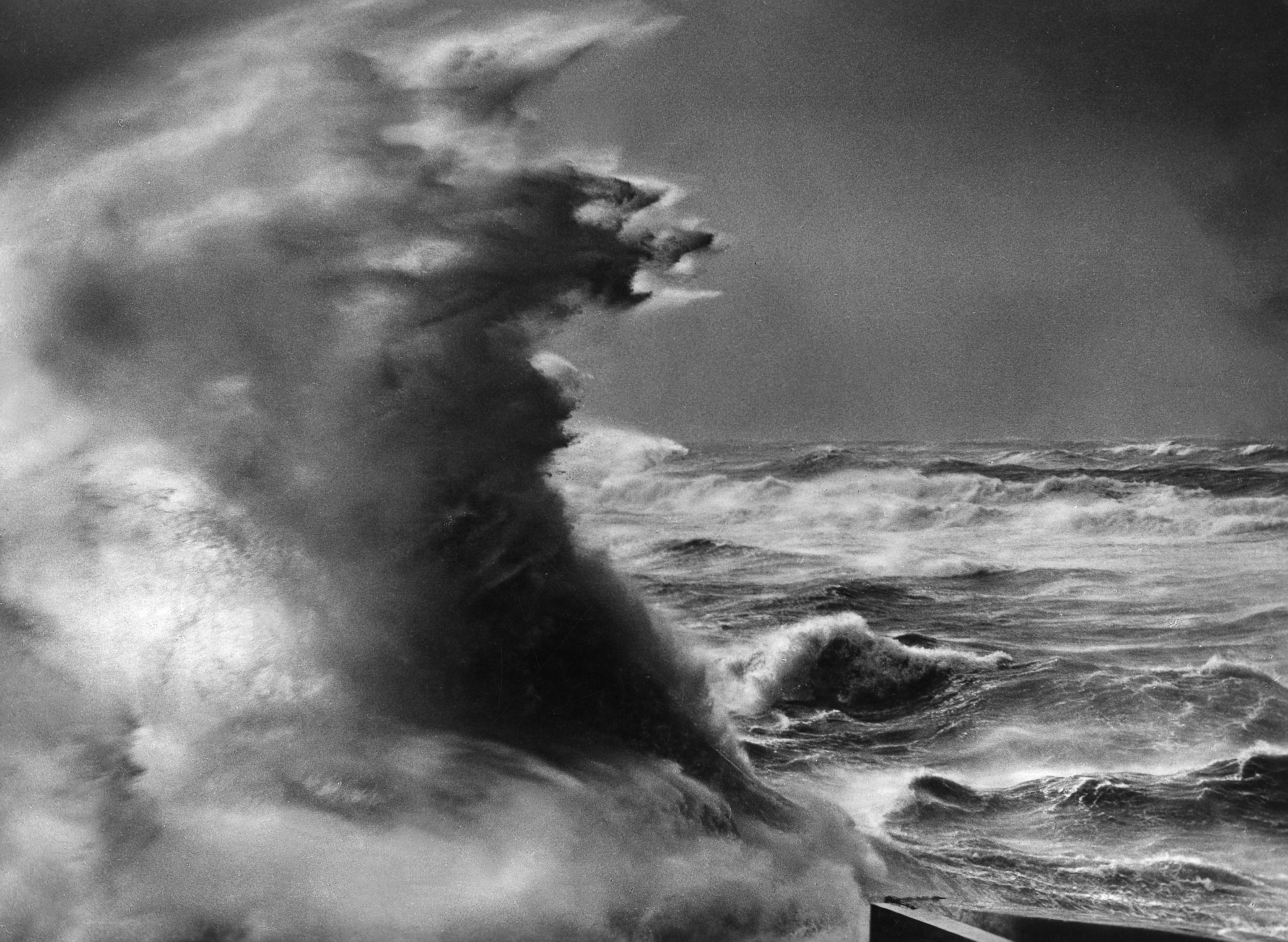 a black and white photograph of a stormy sea